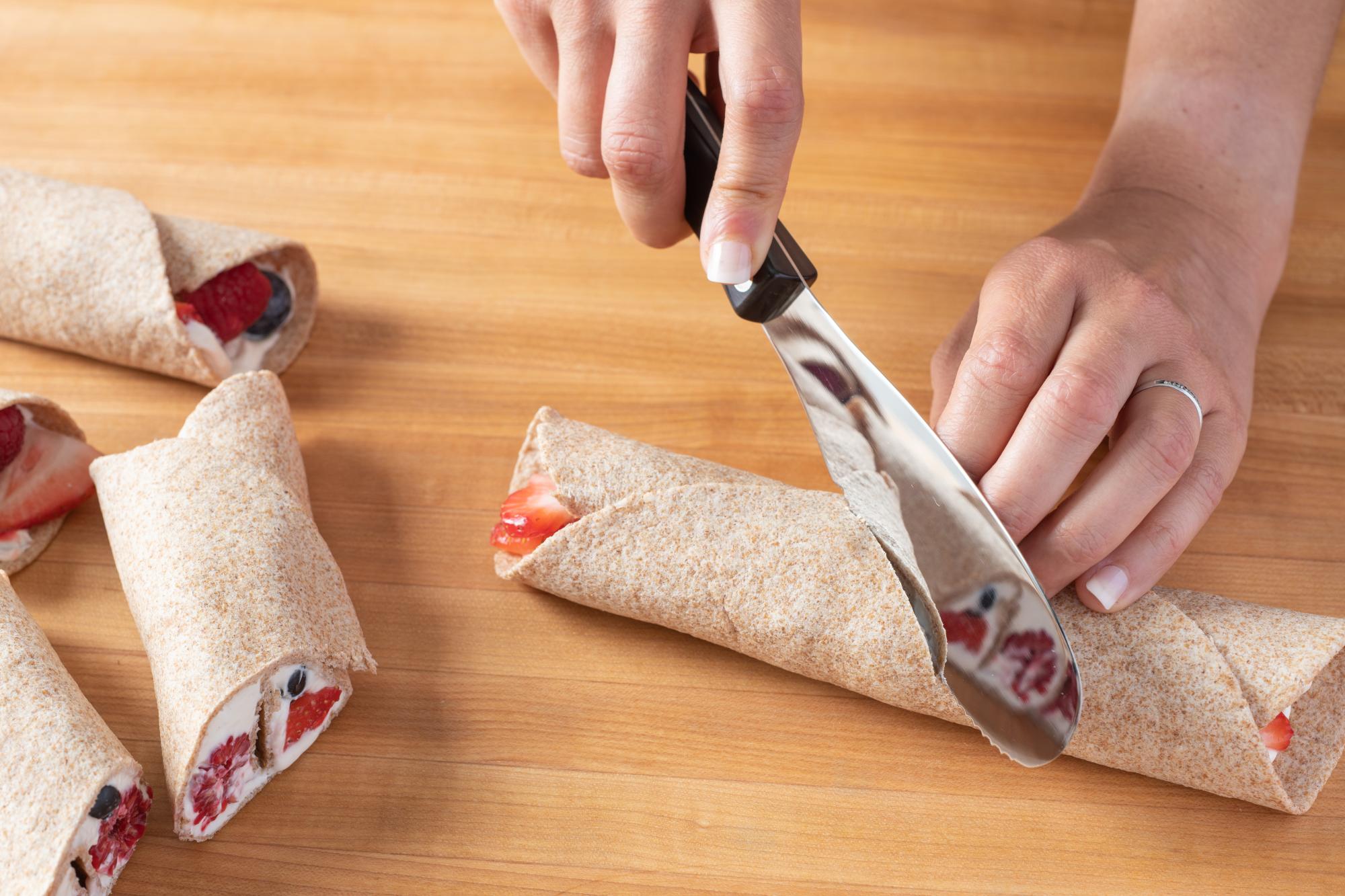 You can use the Spatula Spreader to cut the wraps in half.