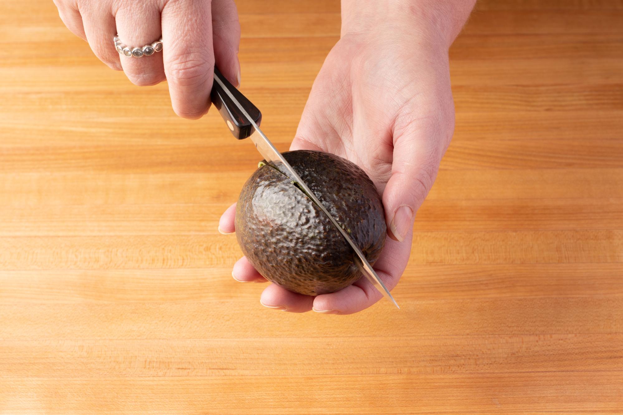 Cut around the avocado with a 4 Inch Paring Knife.