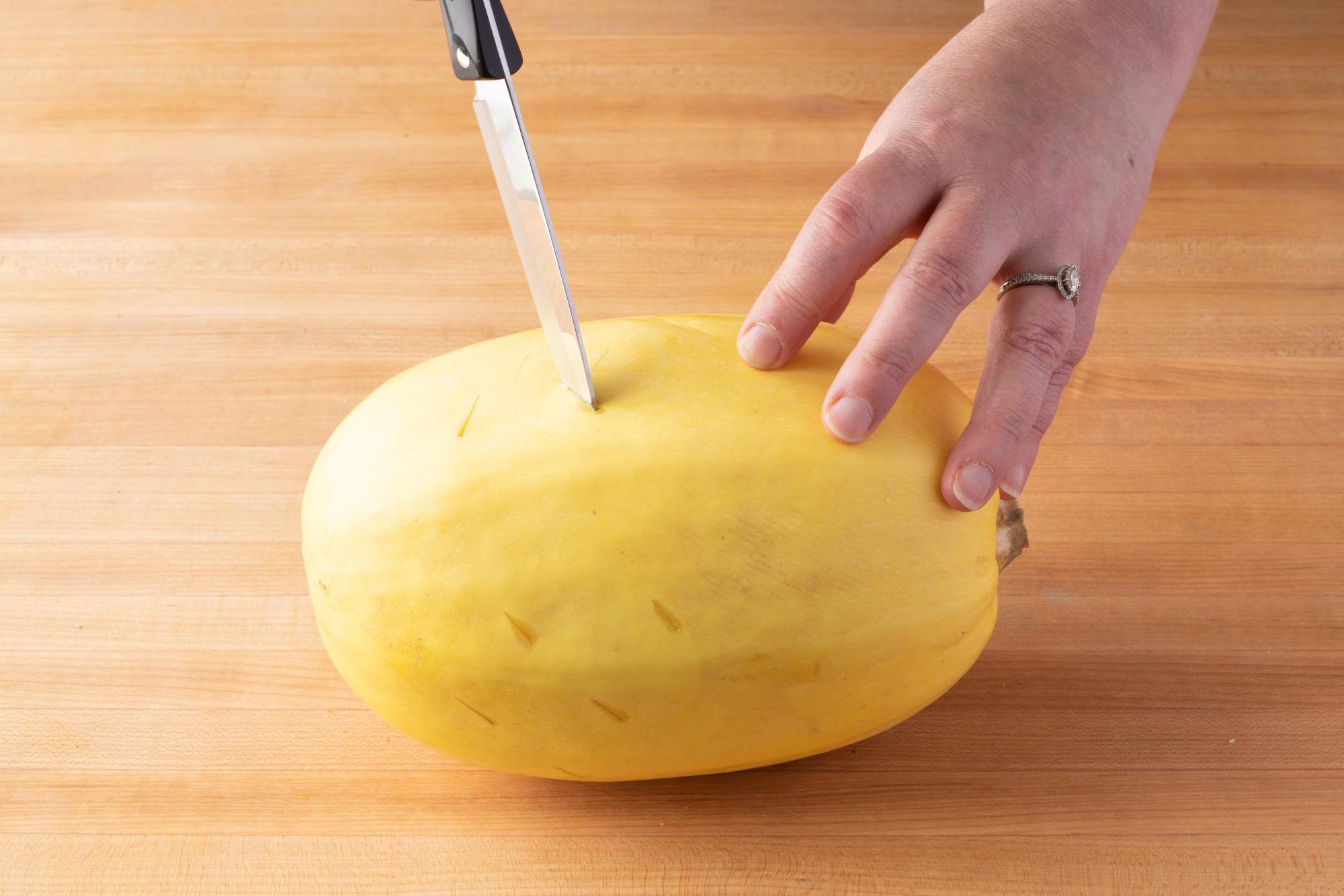 Piercing the outside of the squash with a 4 Inch Paring knife.