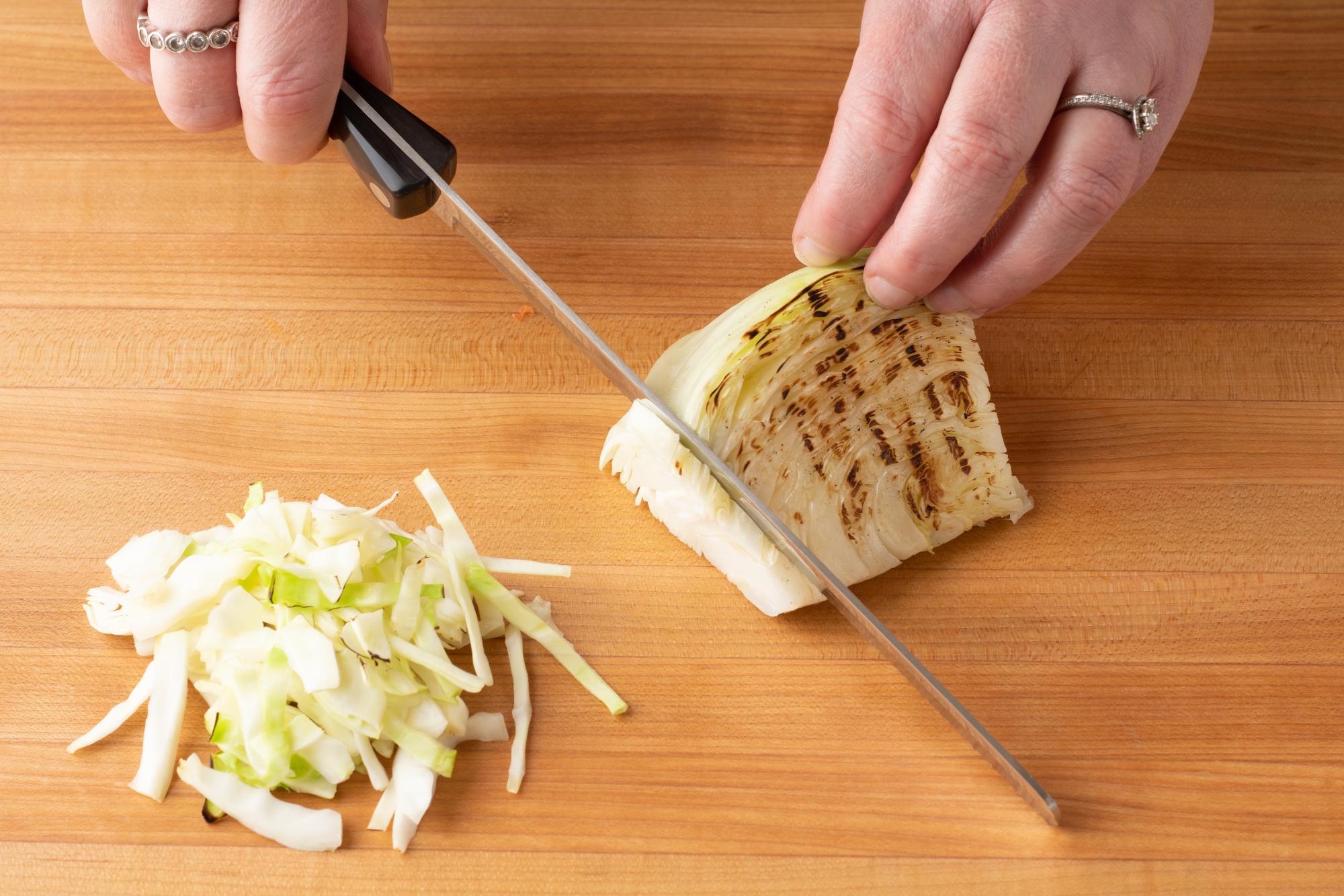 Using a Petite Slicer to cut the cabbage into thin strips.
