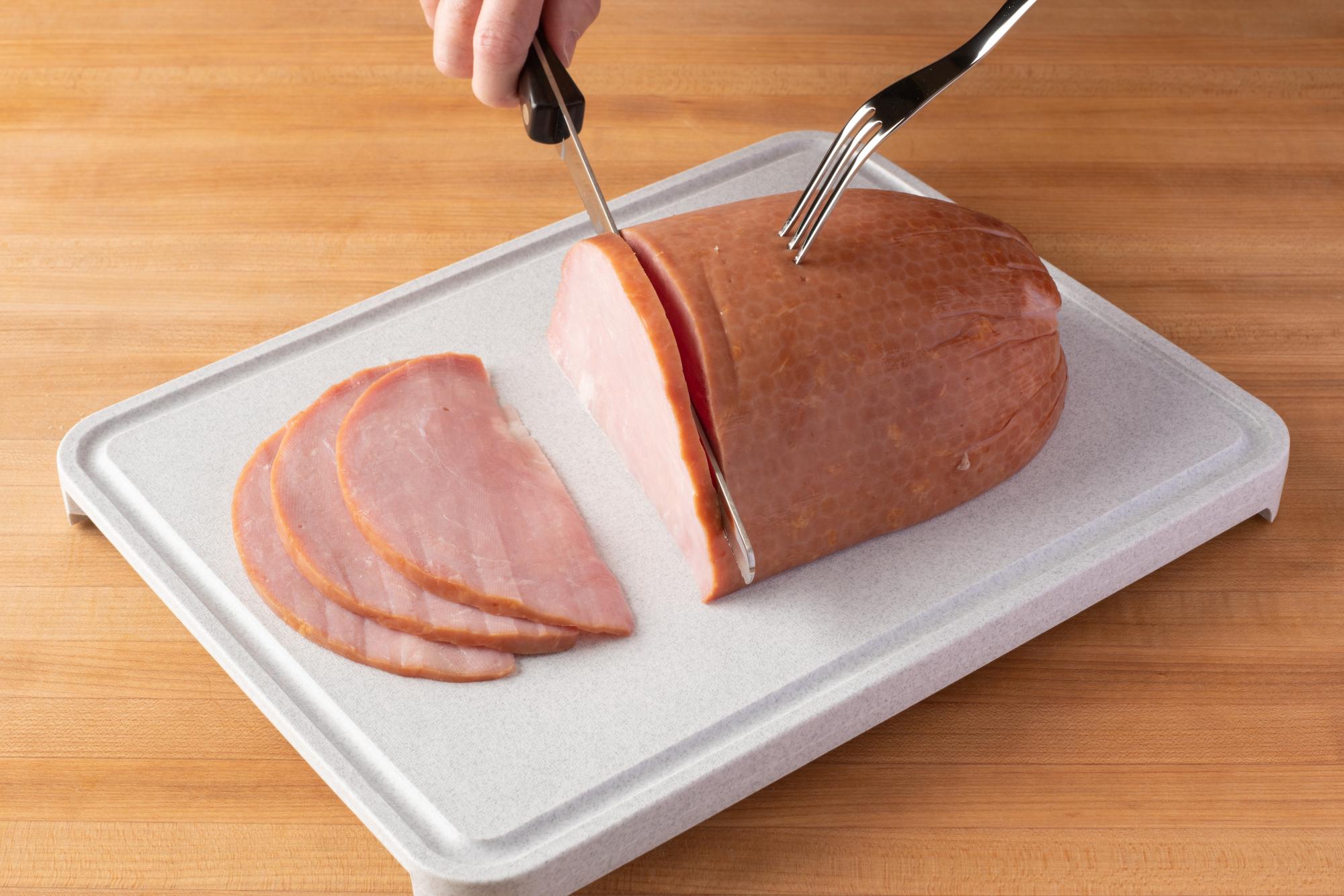 Using a Petite Slicer to slice a Ham.