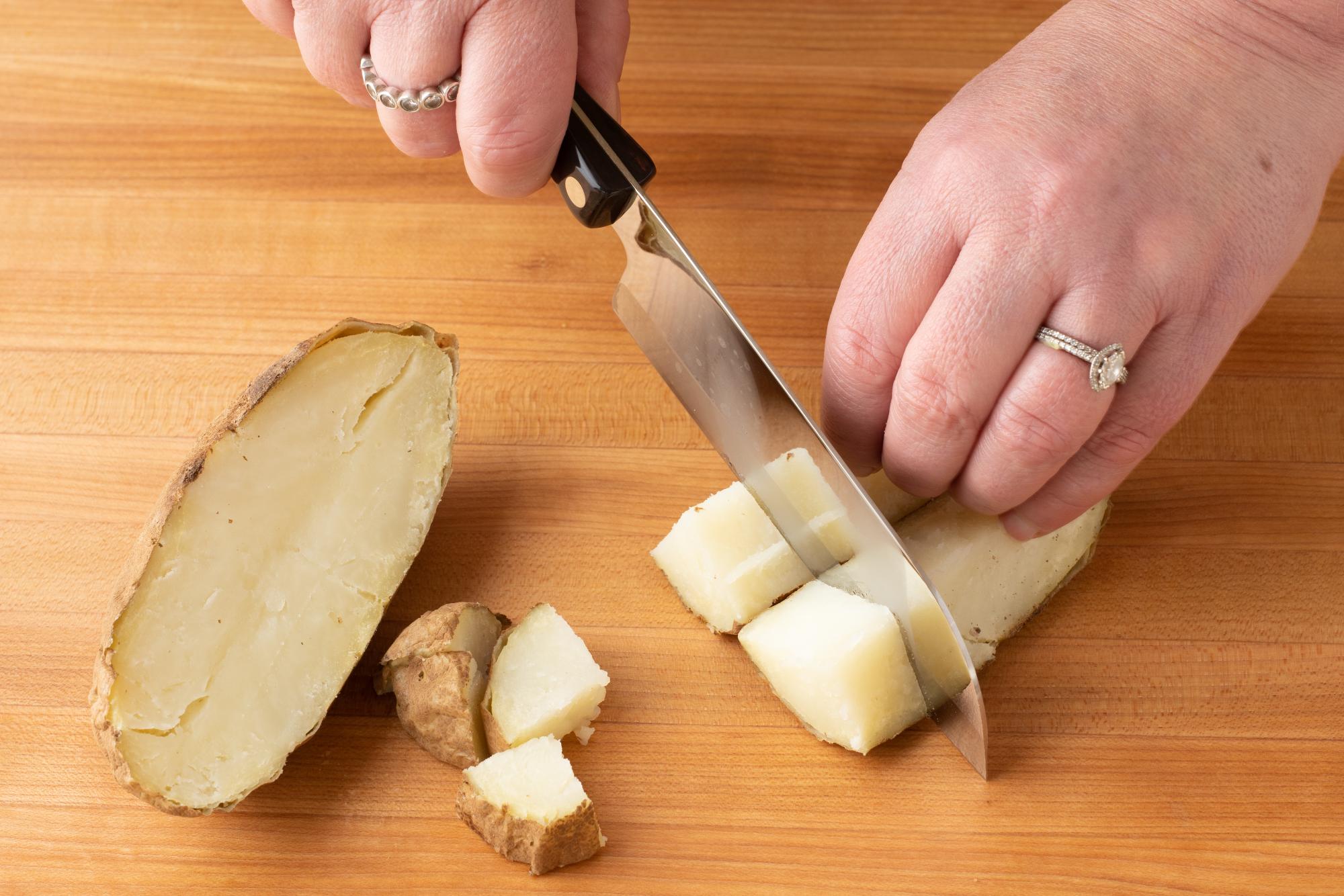 Cutting the potatoes into cubes with a Petite Santoku.