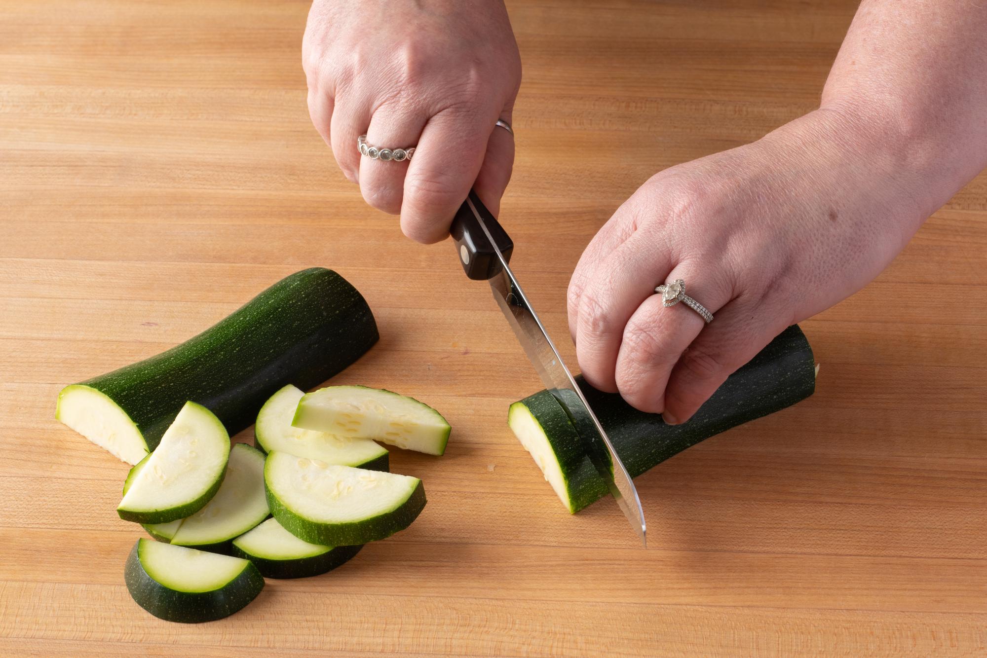 Santoku Style Trimmer cutting squash.