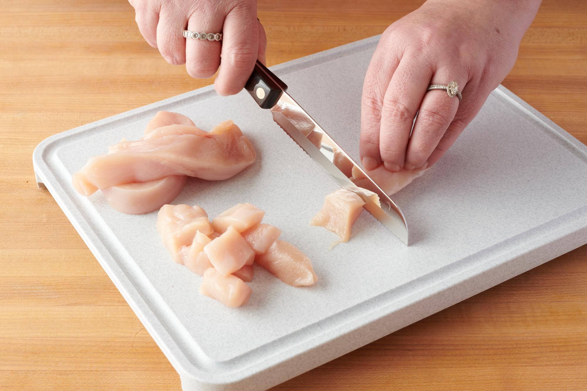 Cutting the chicken breasts with a Santoku-Style Trimmer.