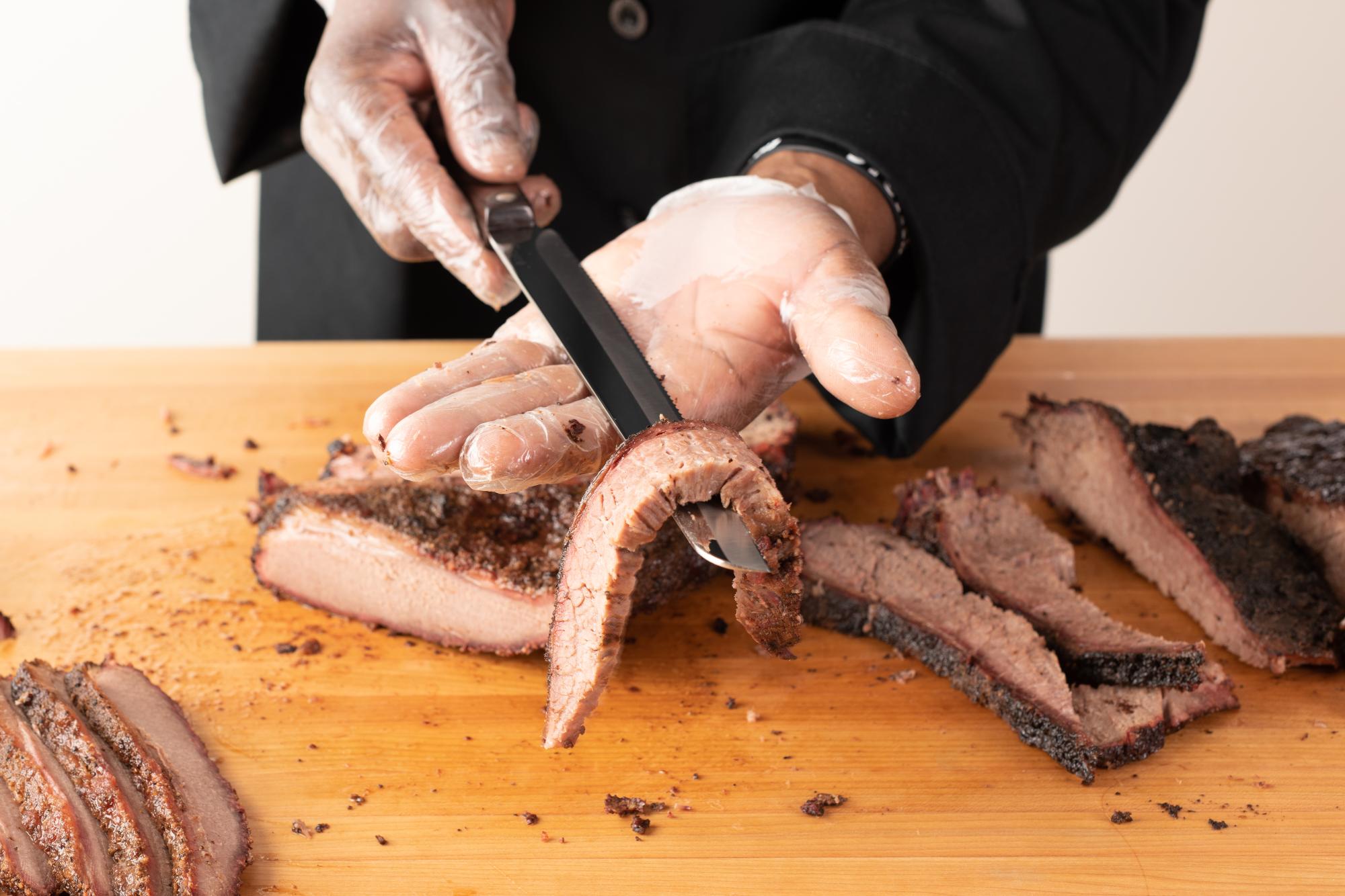 Holding the Brisket over a Santoku-Style Slicer