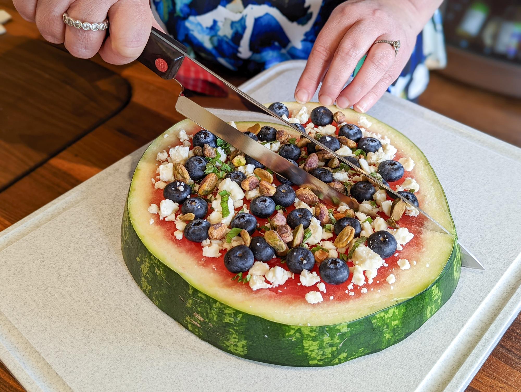 Slicing the pizza with a French Chef.