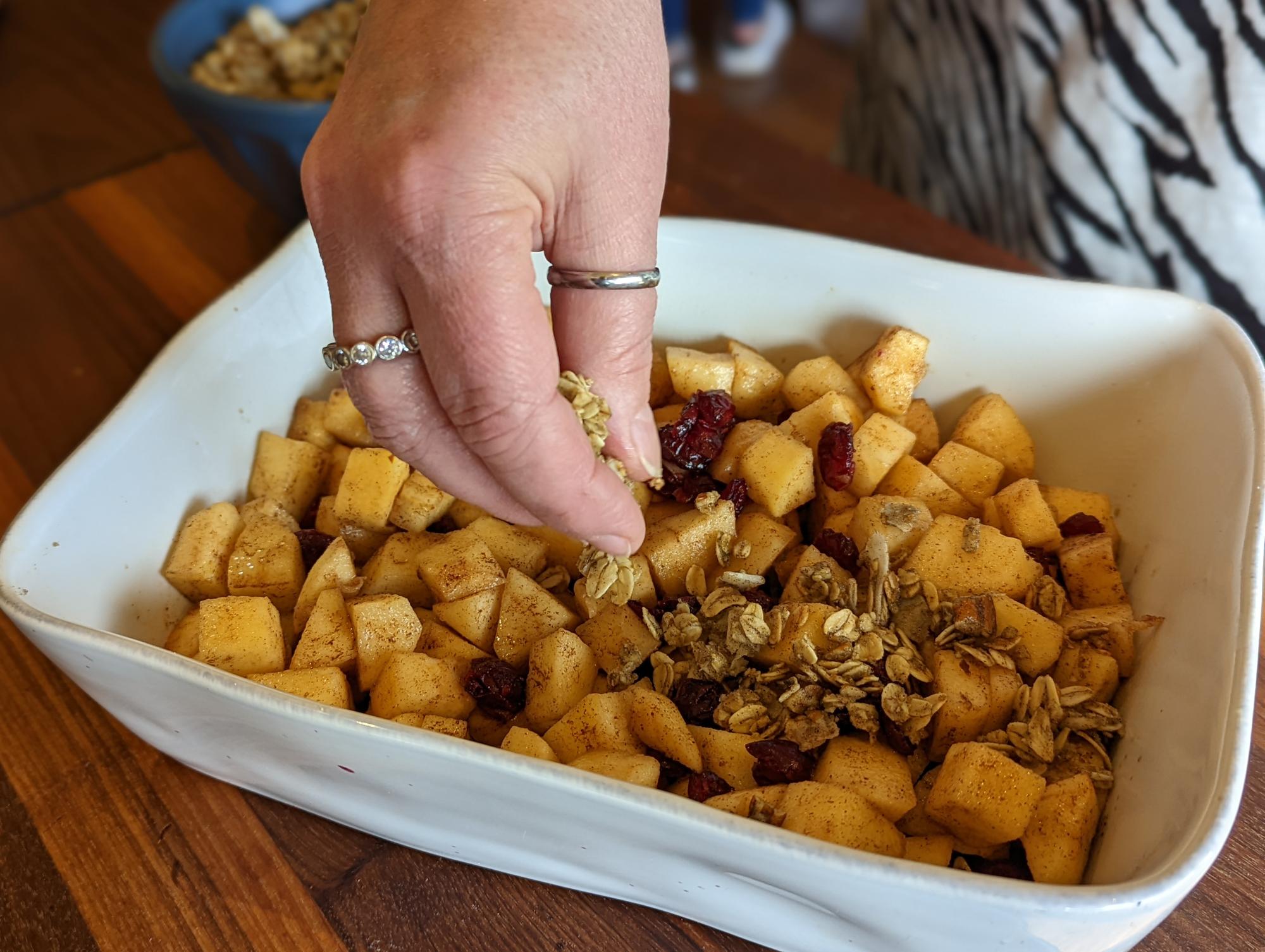 Adding crumble to the top of the fruit.