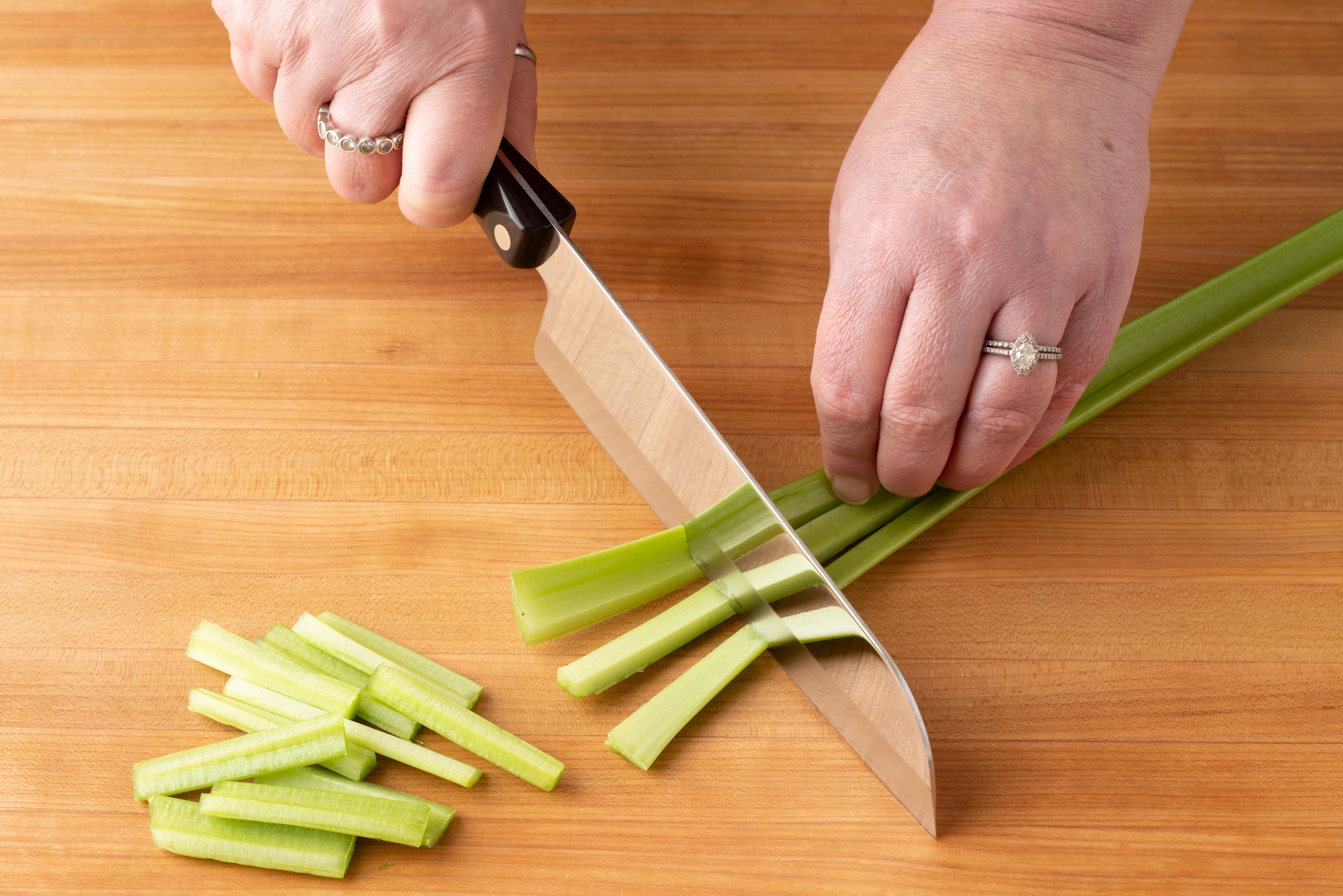 Cutting celery batons with a Santoku.