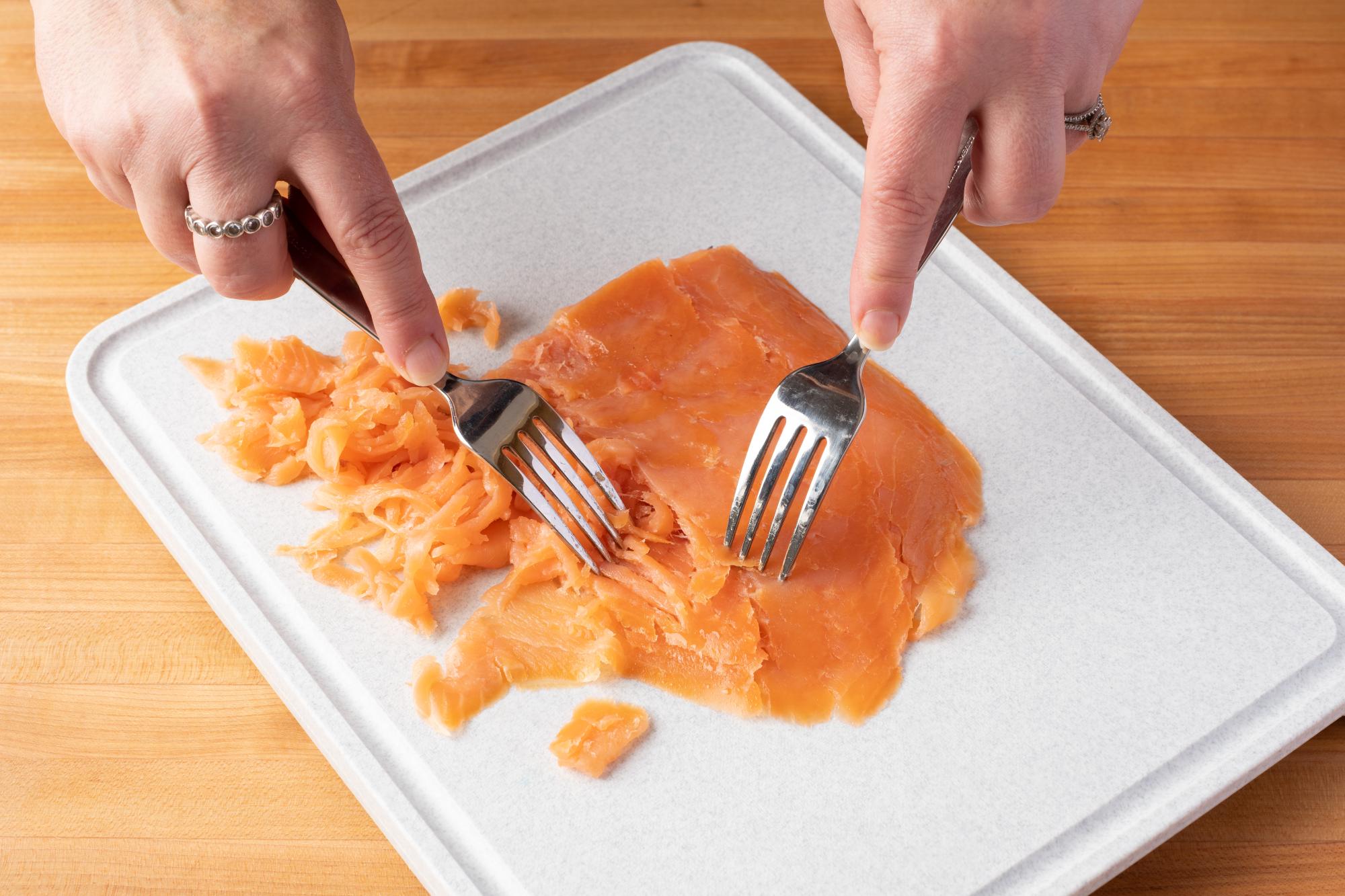 Flake the salmon with two forks.