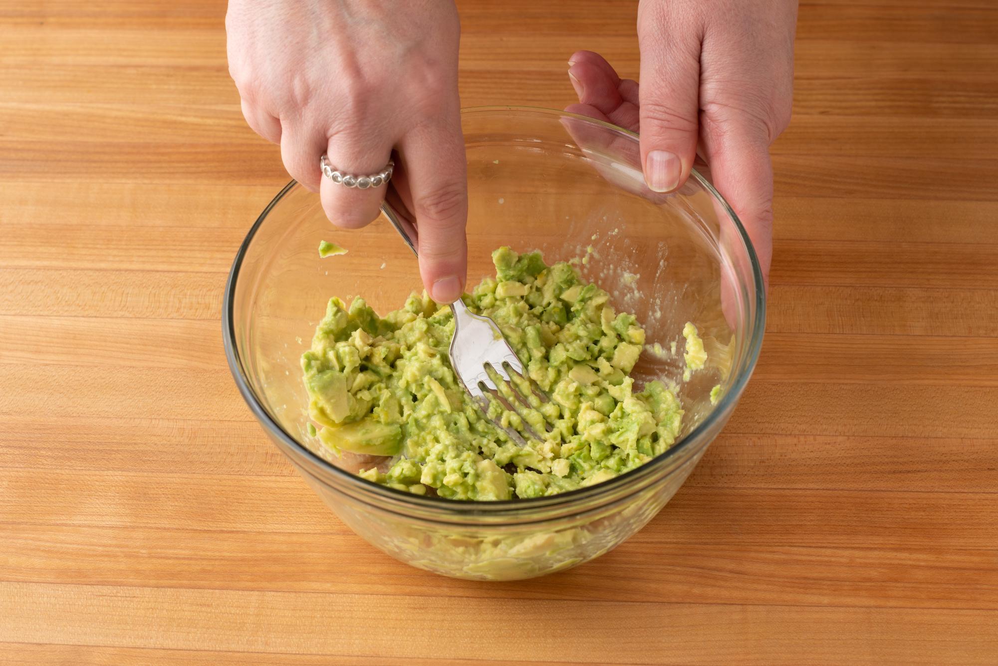 Mashing avocado with a Fork.