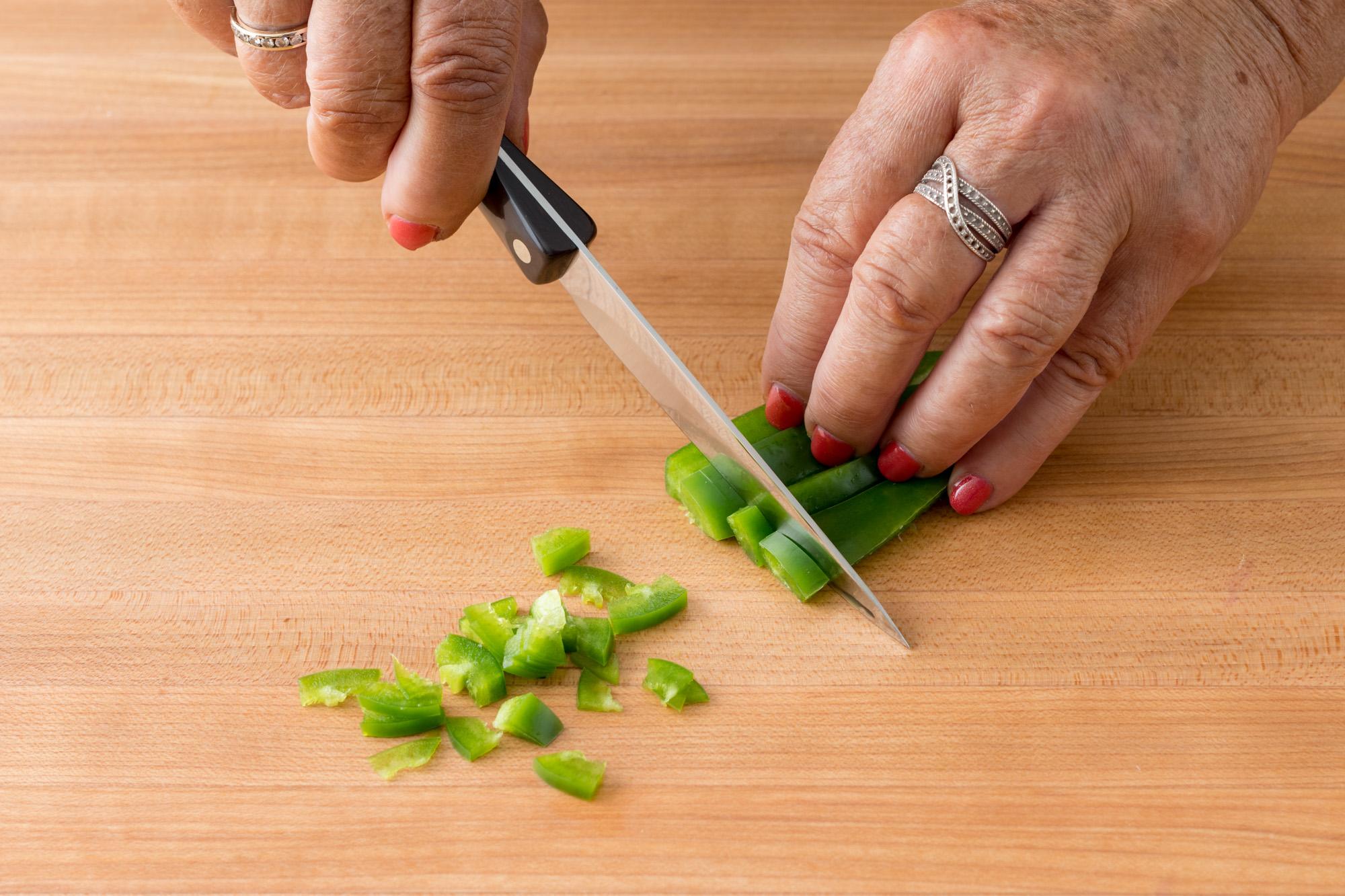 Using a 4 Inch Gourmet Paring Knife to mince the jalapeno.