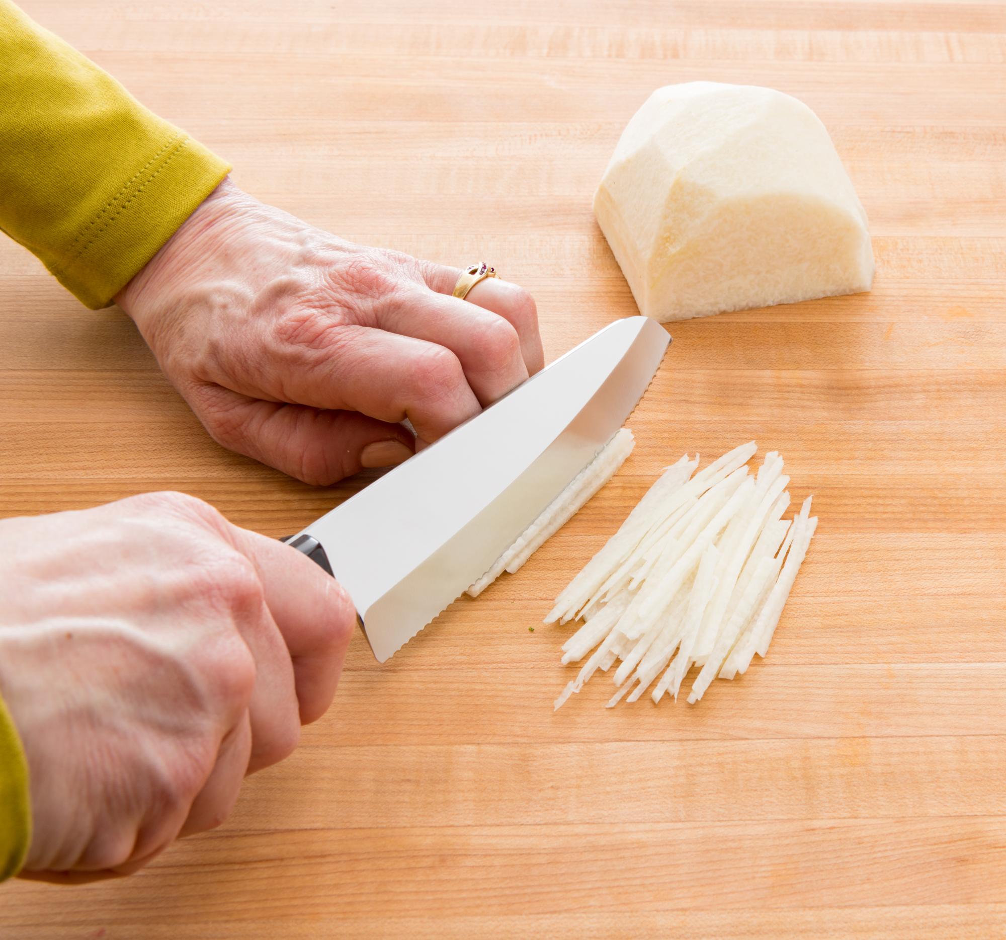 Slicing the jicama with a Hardy Slicer.