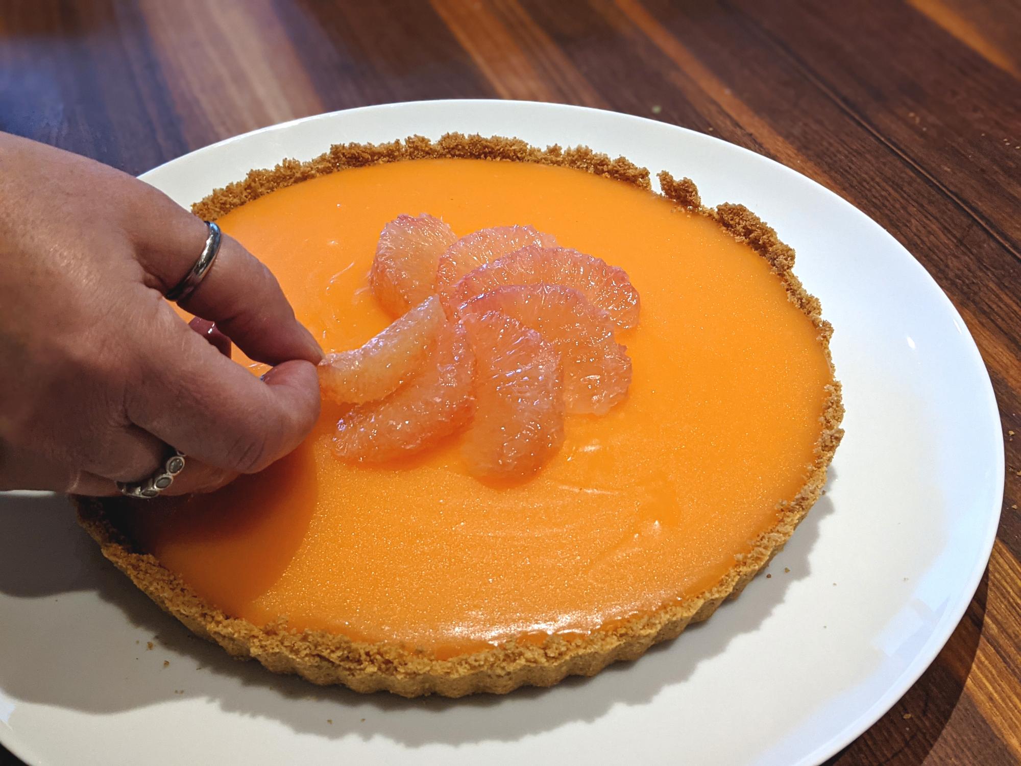 Placing the grapefruit on the tart.
