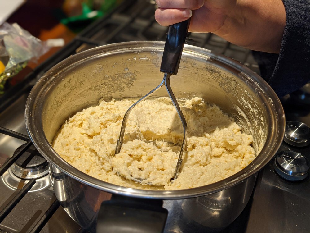 Mashing the parsnips with the Potato Masher.