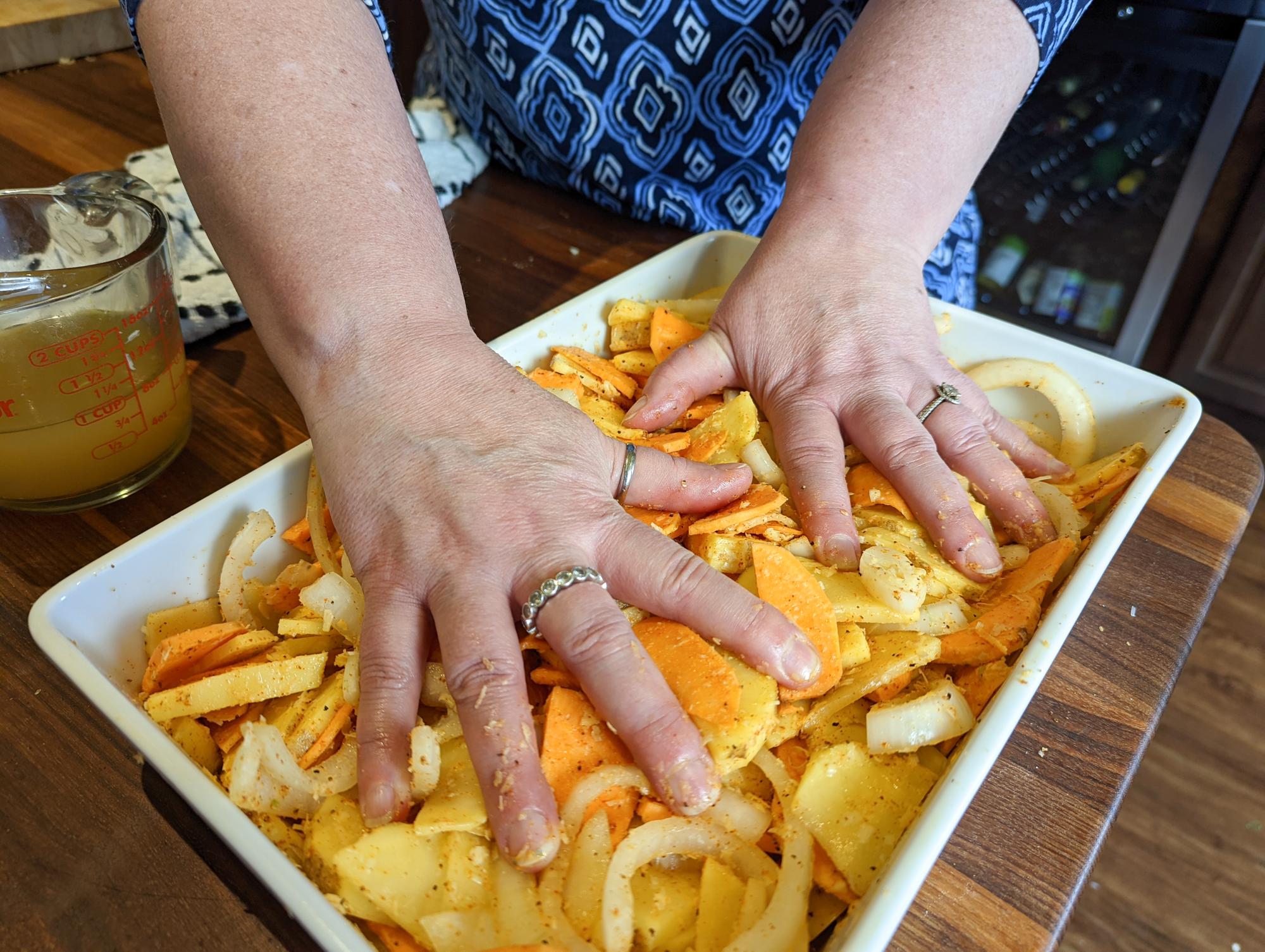 Pressing down on the onions and potatoes.