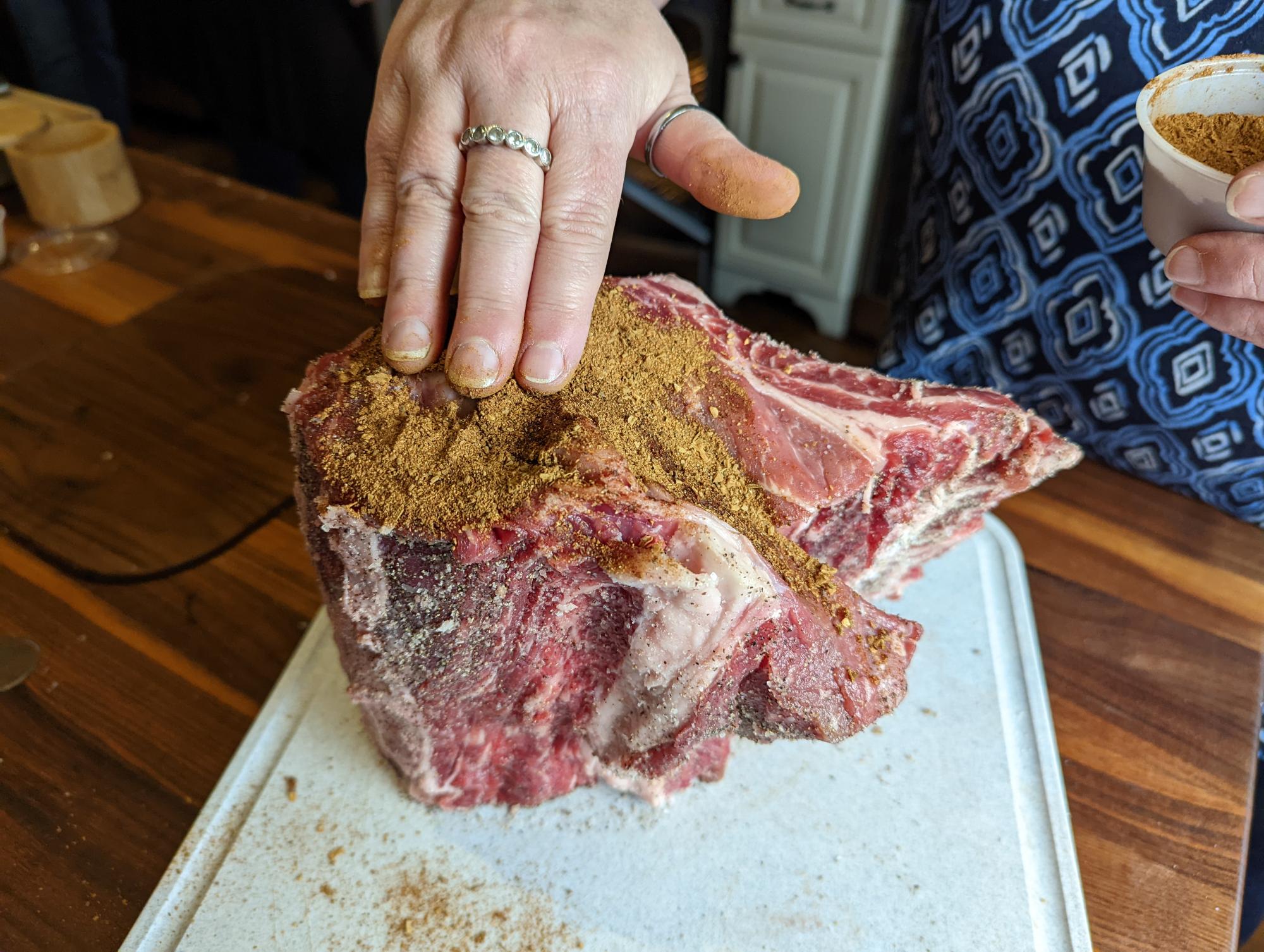 Putting rub on rib roast.