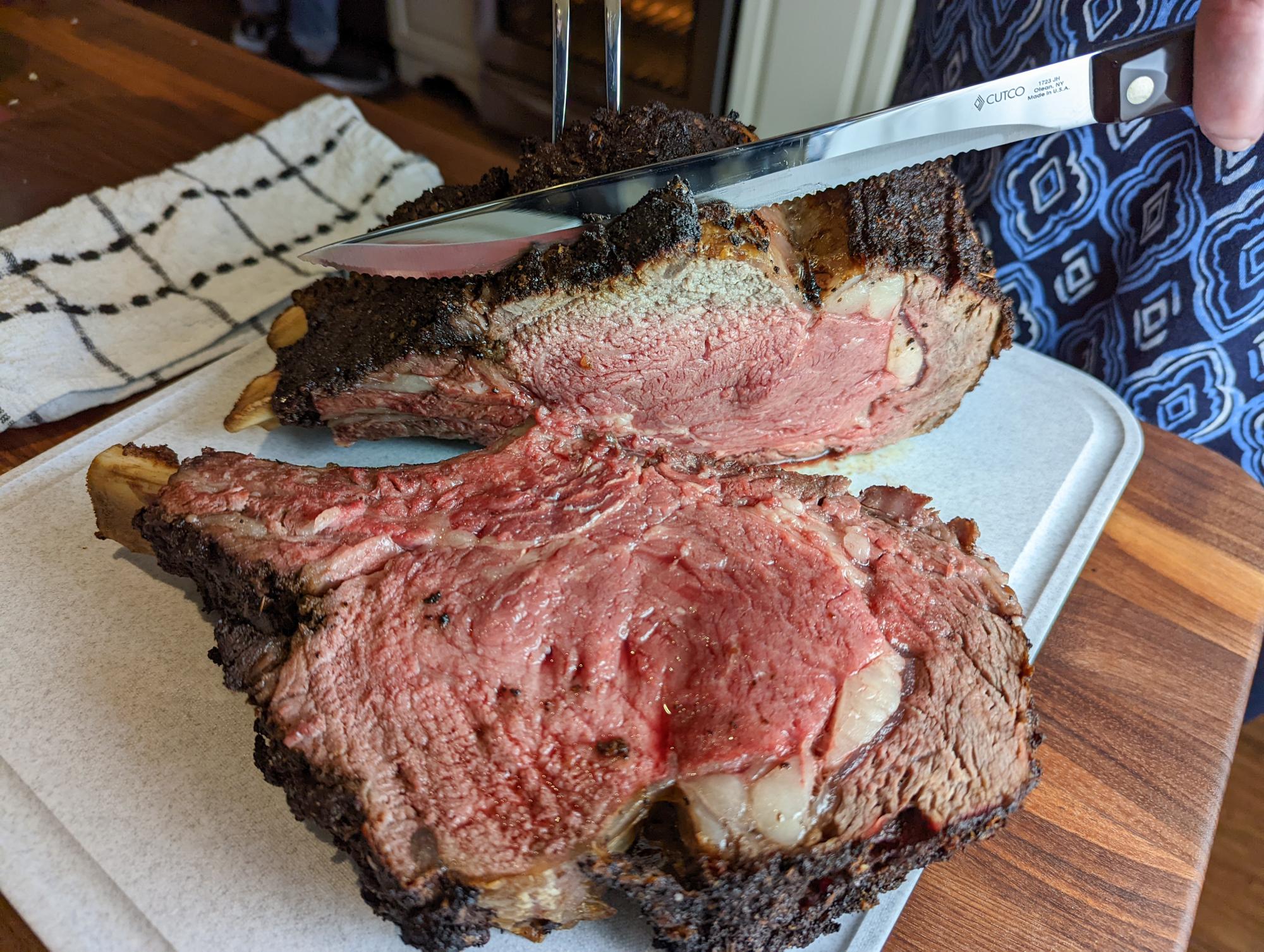 Sliced Roasted Prime Rib With Knife On Plank Stock Photo