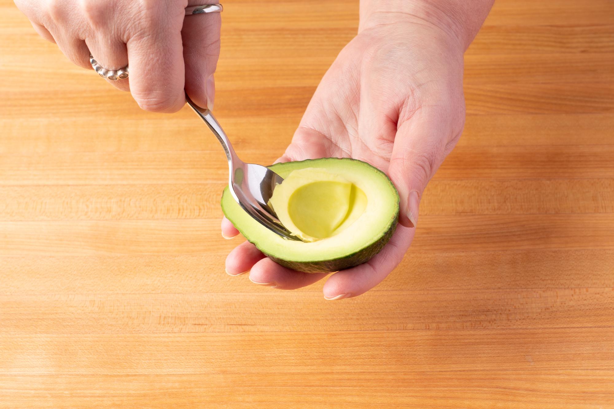 Use a spoon to scoop out the avocado.