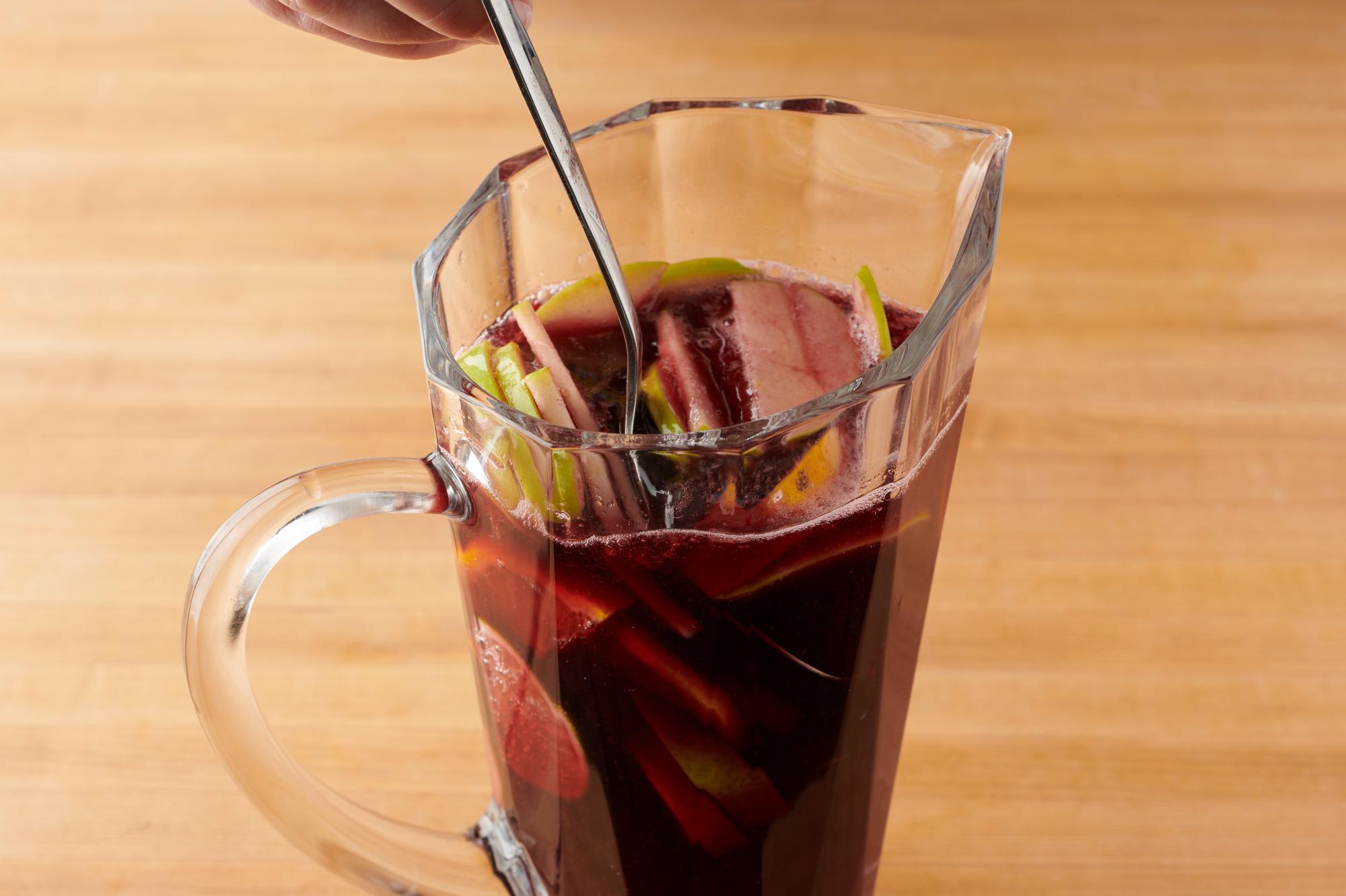 Stir the Sangria with a large spoon.