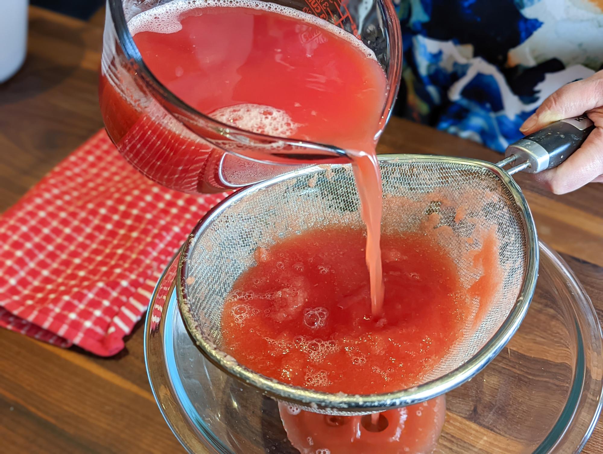 Straining the watermelon.