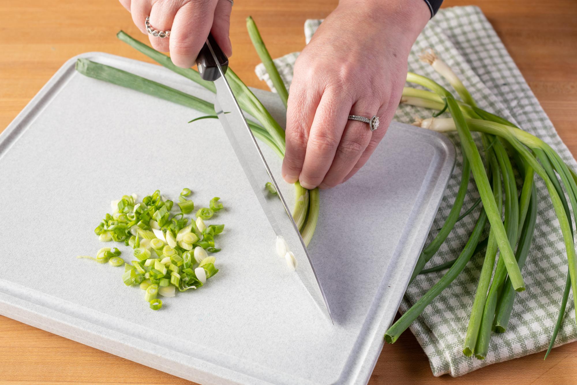 Slicing the green onions with a Petite Chef.