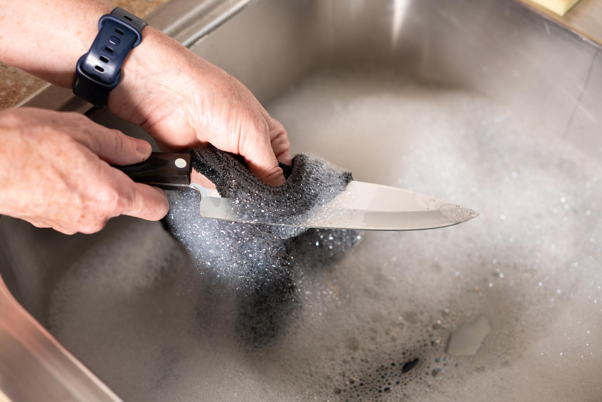 Hand washing a knife.