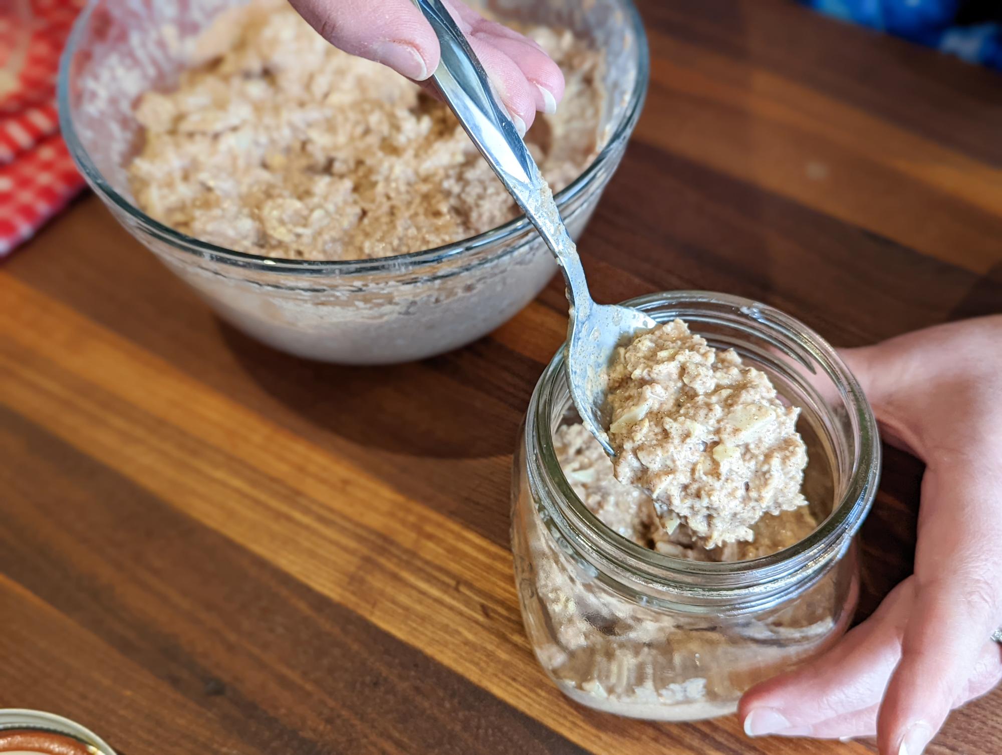 Spooning the oats into jars.