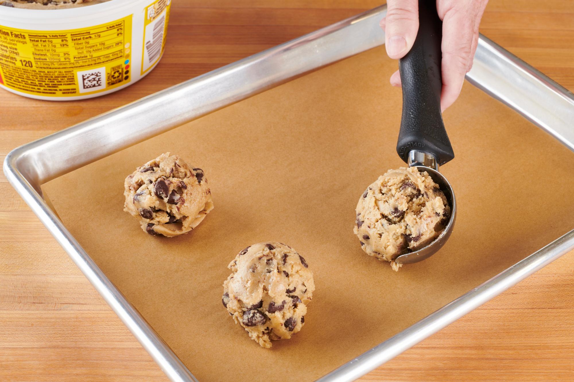 Scooping cookie dough with an Ice Cream Scoop.