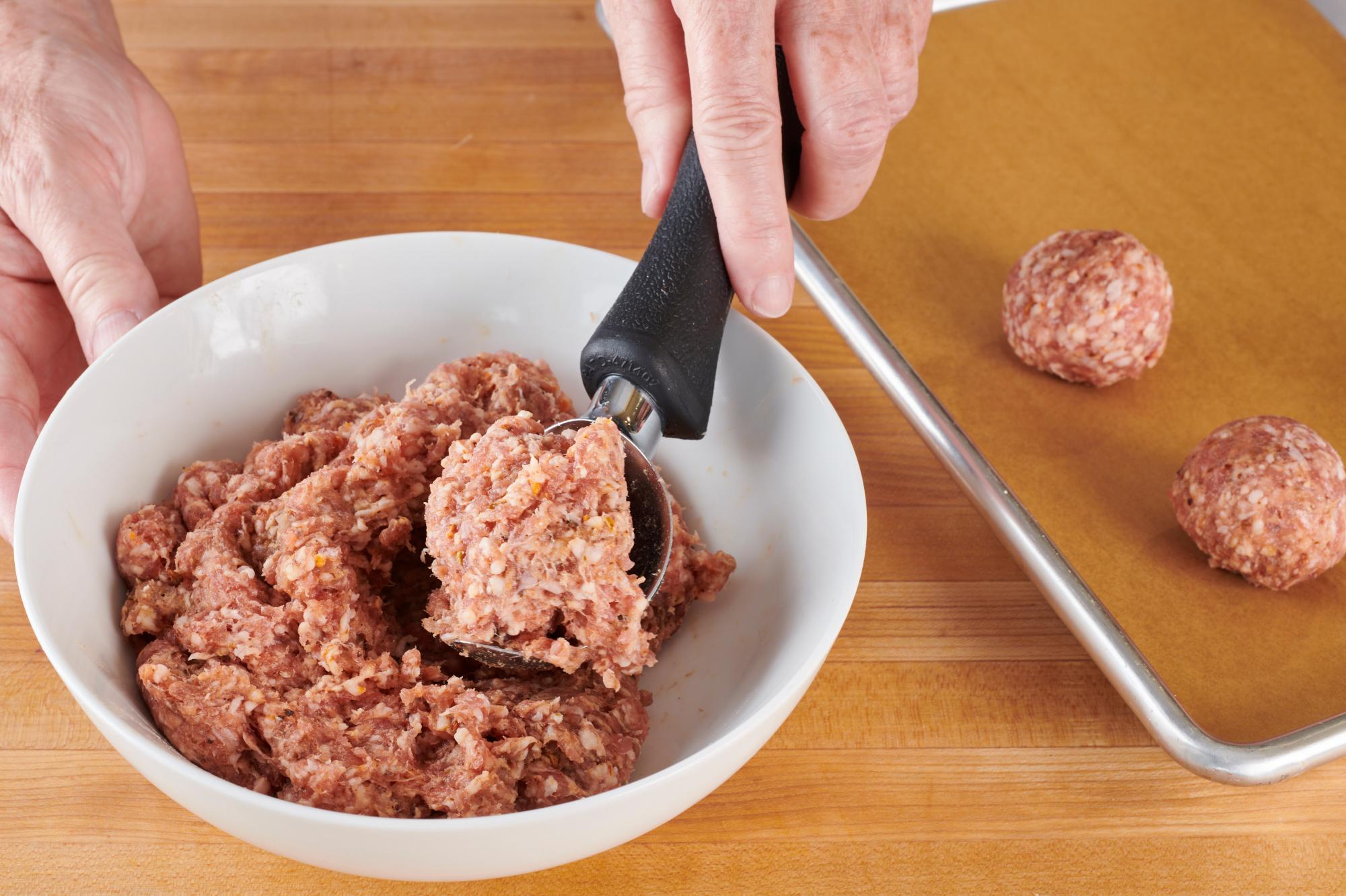Scooping meatballs with an Ice Cream Scoop.