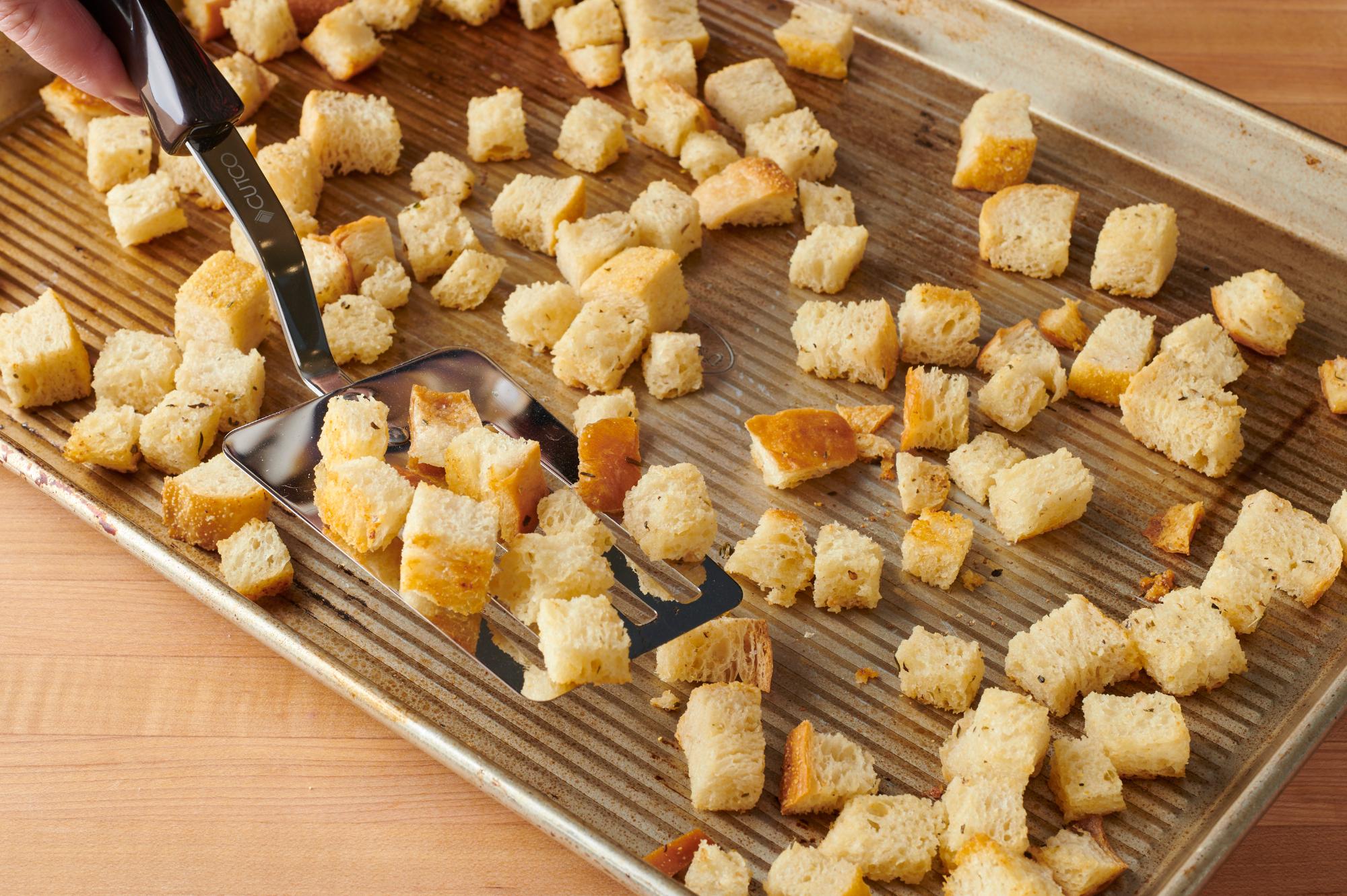 Flipping the croutons with a Slotted Turner.