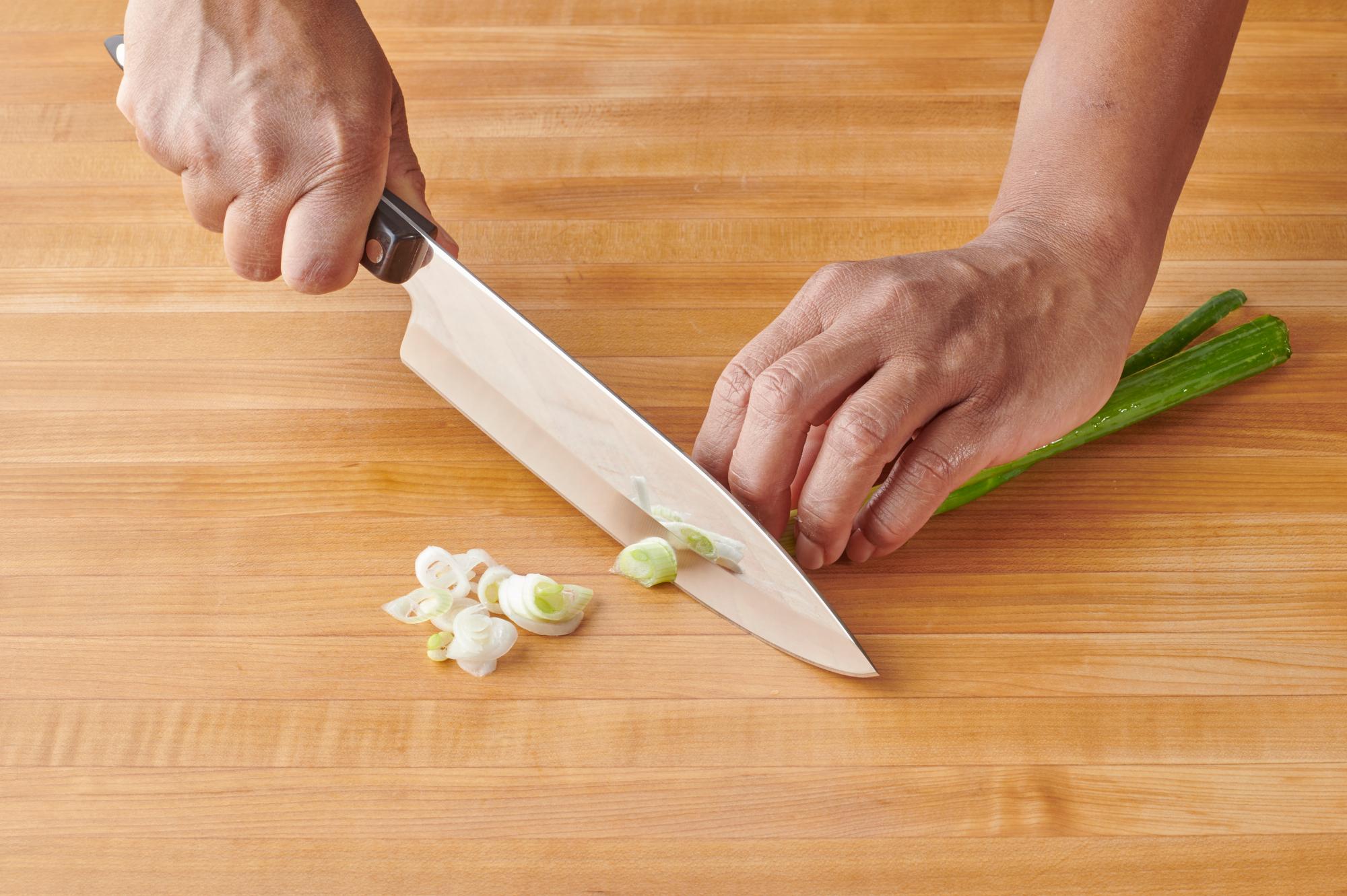 Slicing the scallions with a Petite Chef.