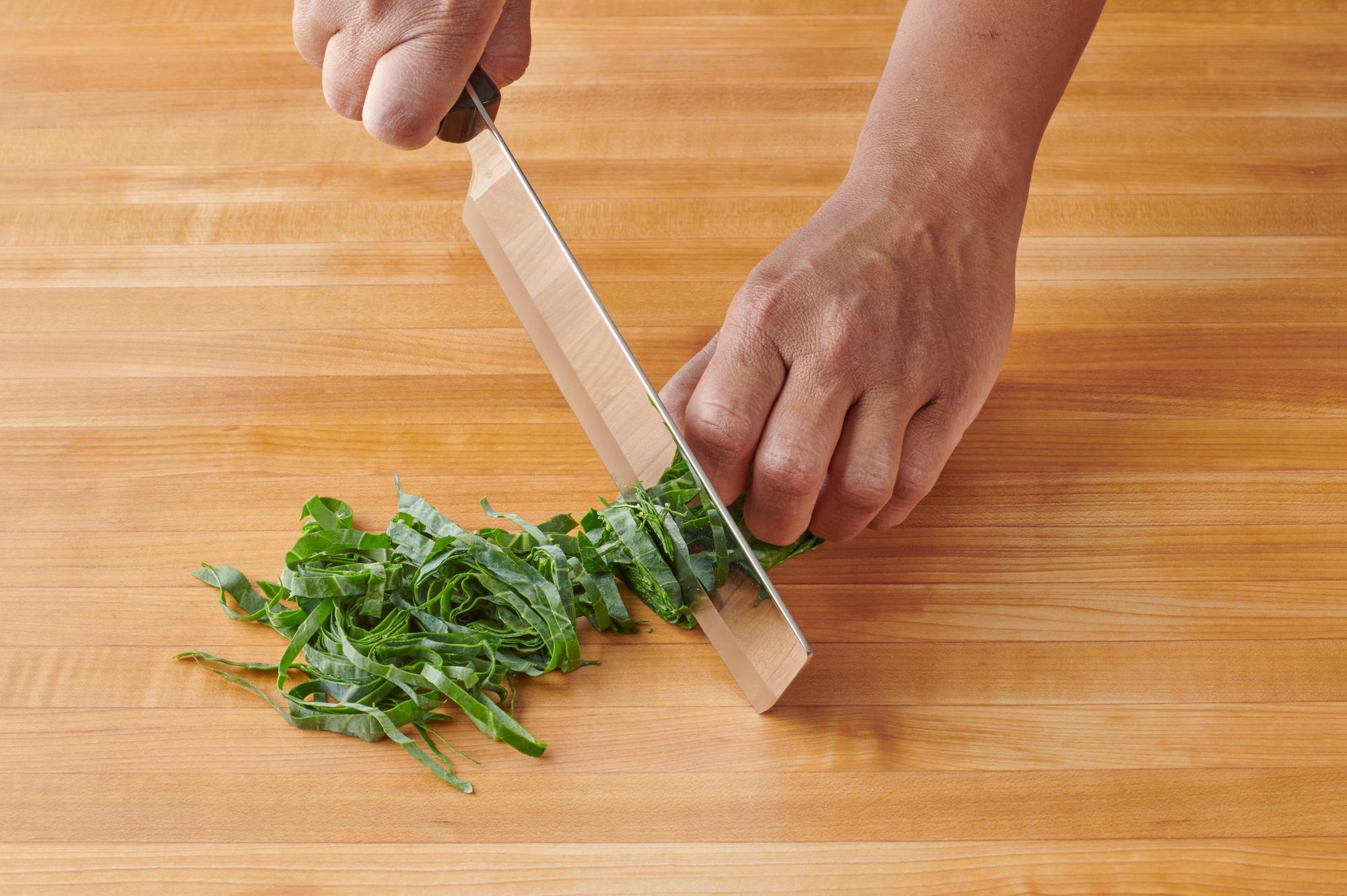 Slicing the collard greens with a Vegetable Knife.