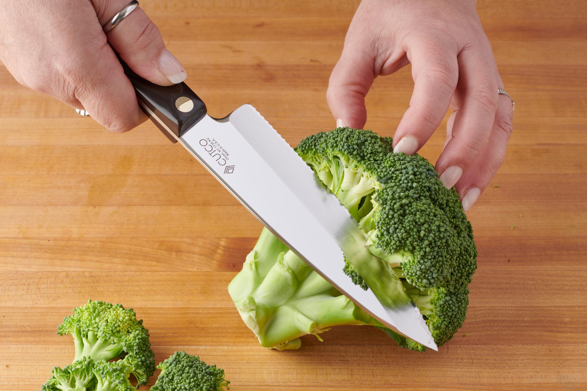 Using a Gourmet Prep knife to cut the broccoli florets.
