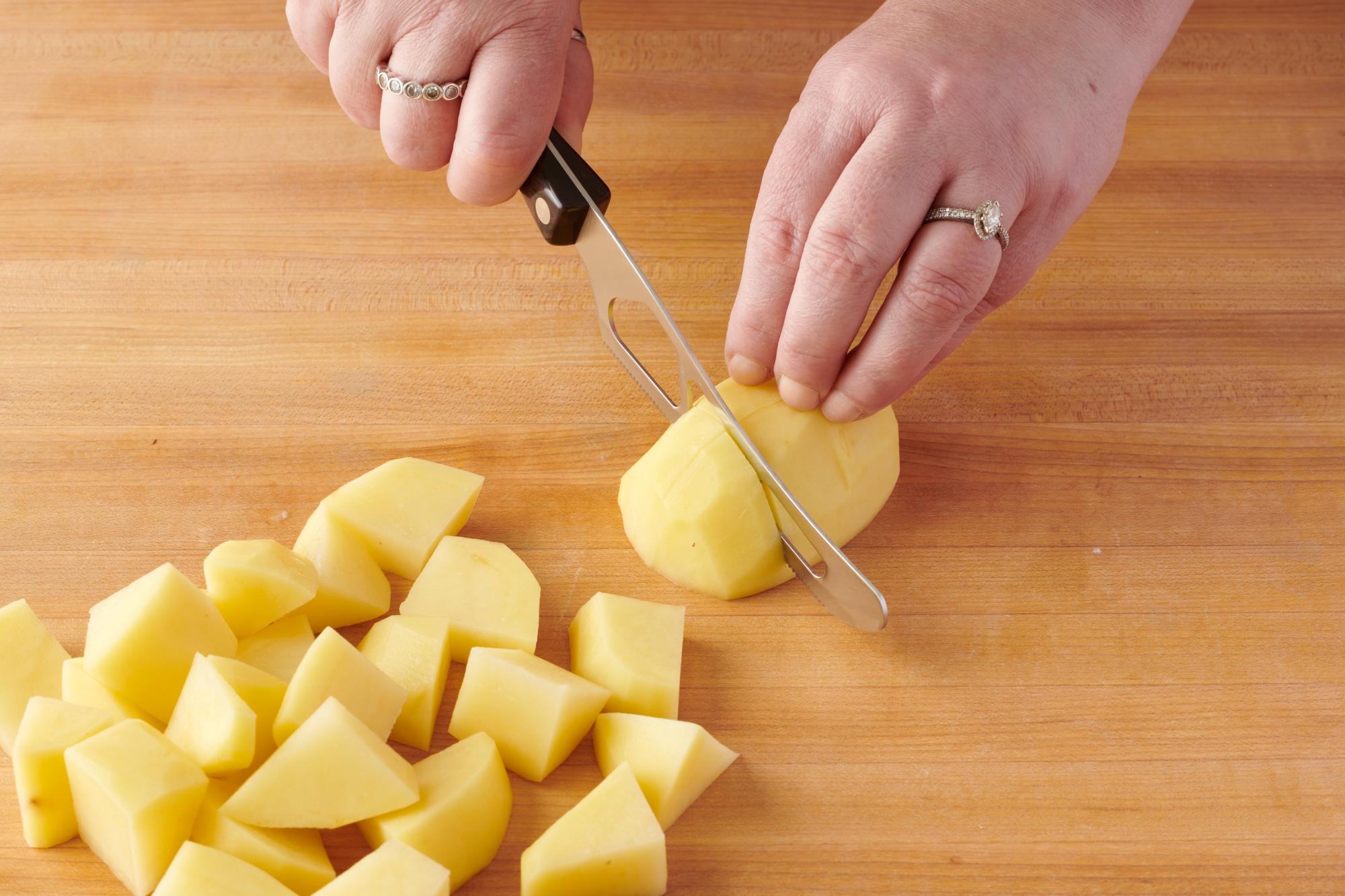 Cutting the potatoes with a Traditional Cheese Knife.
