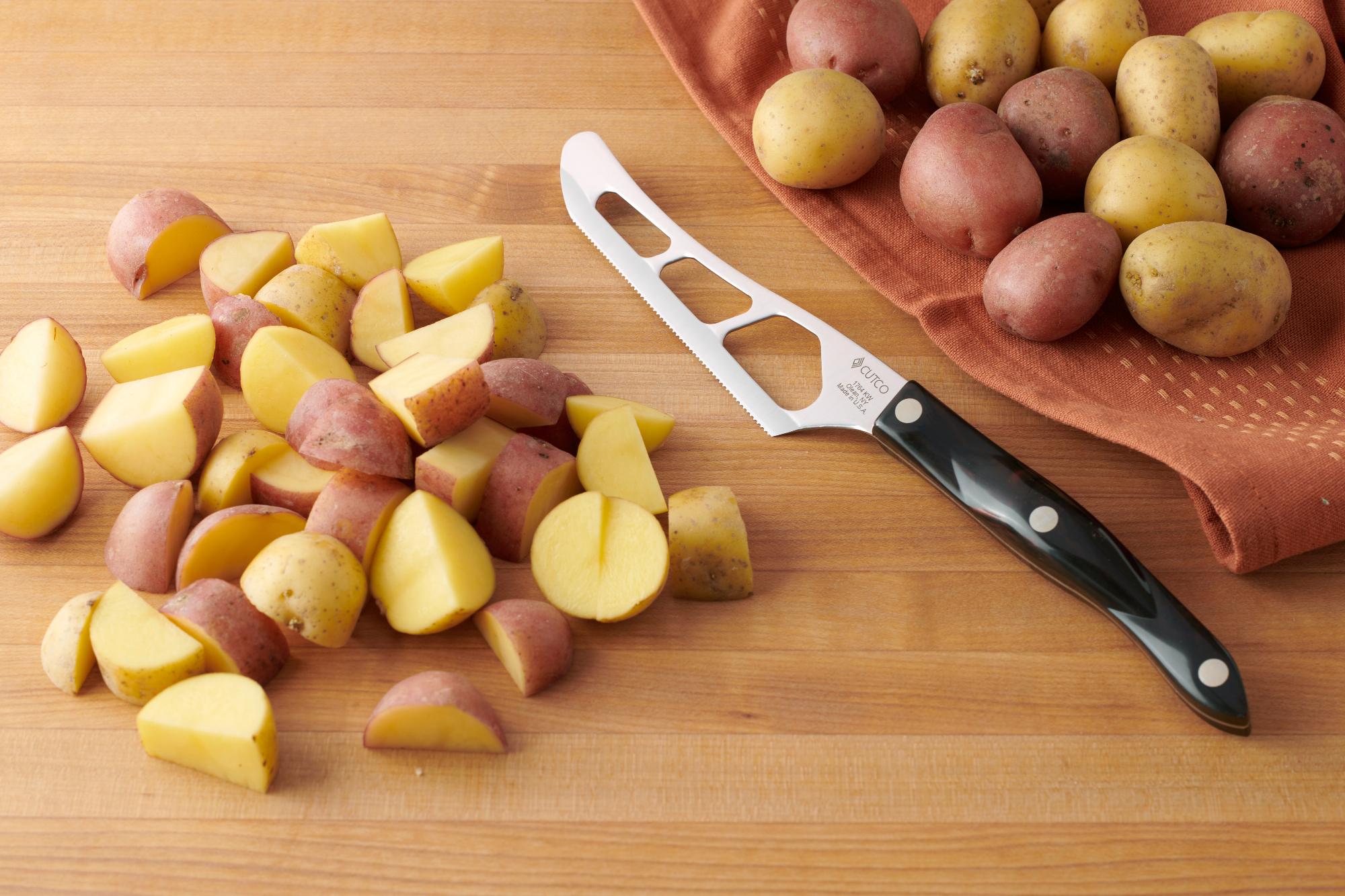 Rough chop the baby potatoes with a Traditional Cheese Knife.