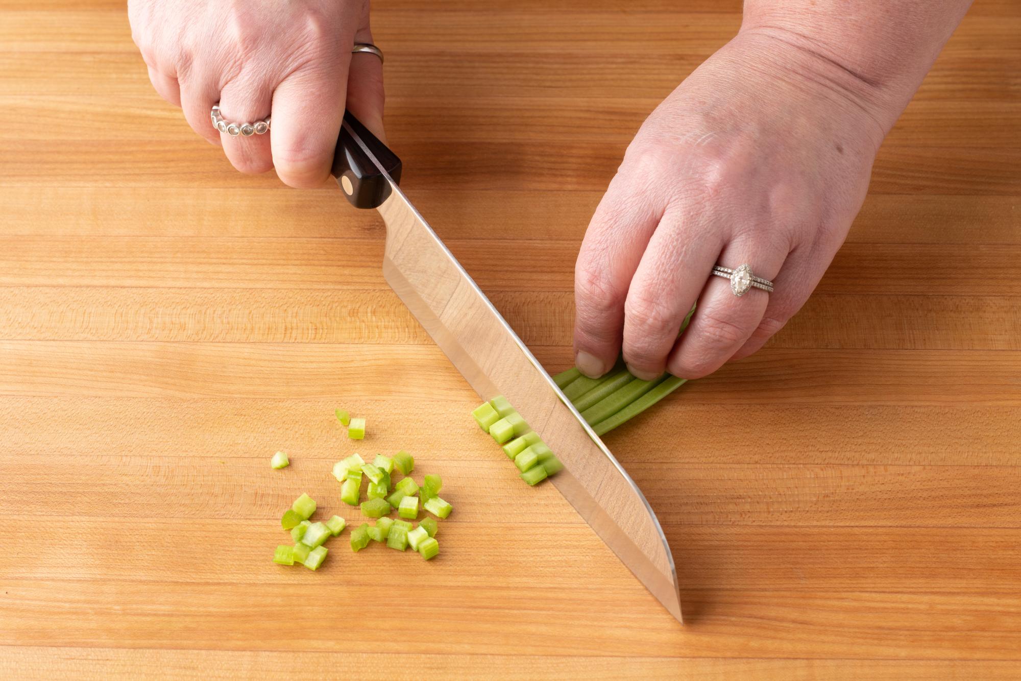 Dicing celery with a Santoku.