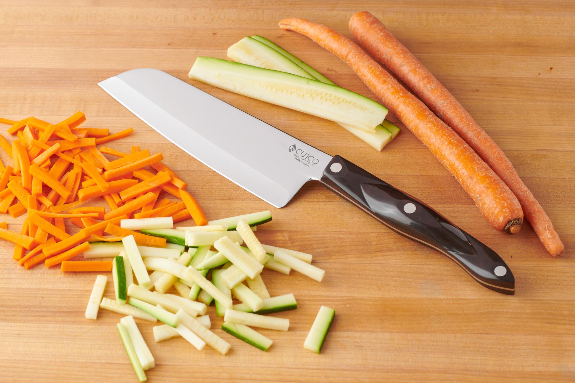 Using the Santoku to cut the zucchini and carrots.