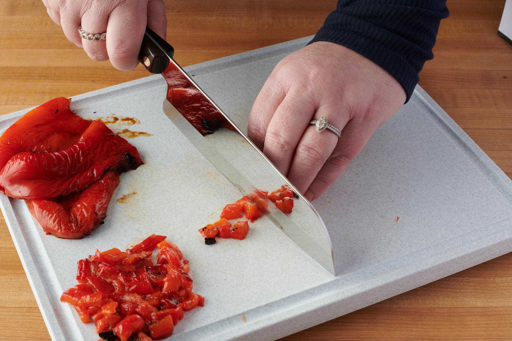 Slicing the red peppers with a Santoku.