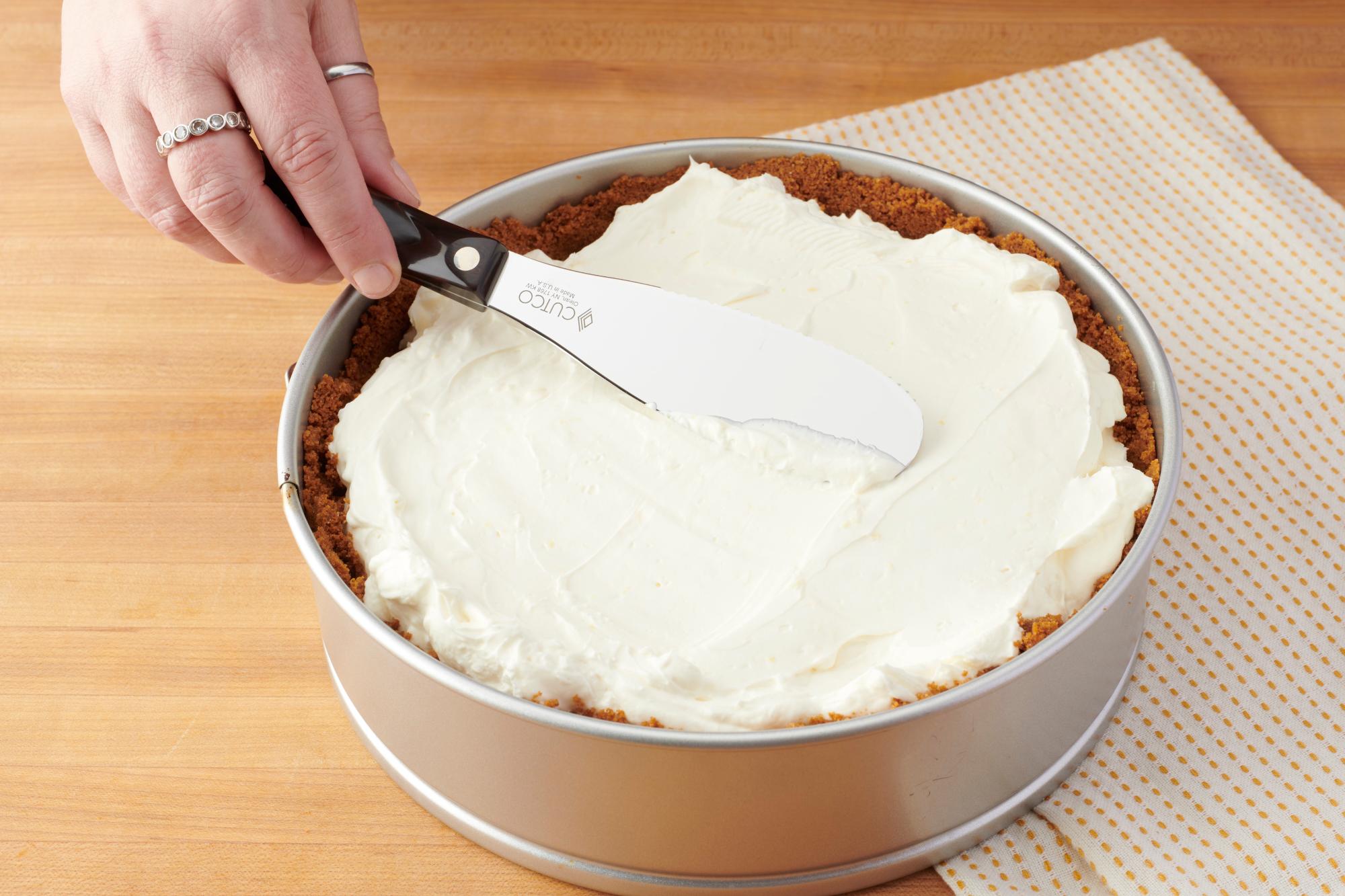 Using a Spatula Spreader to spread the filling.