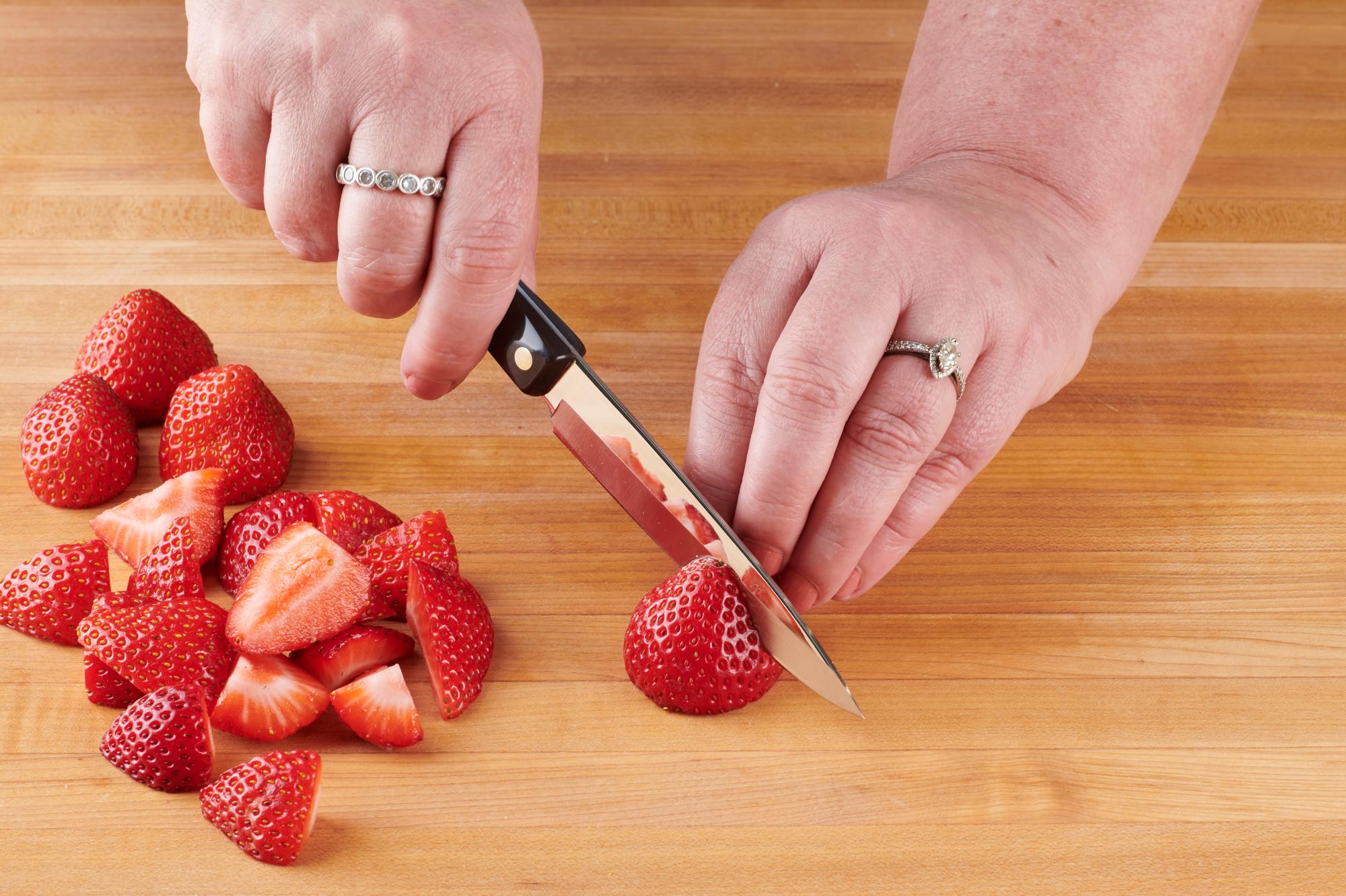 Slicing strawberries with a 4 Inch Paring Knife.