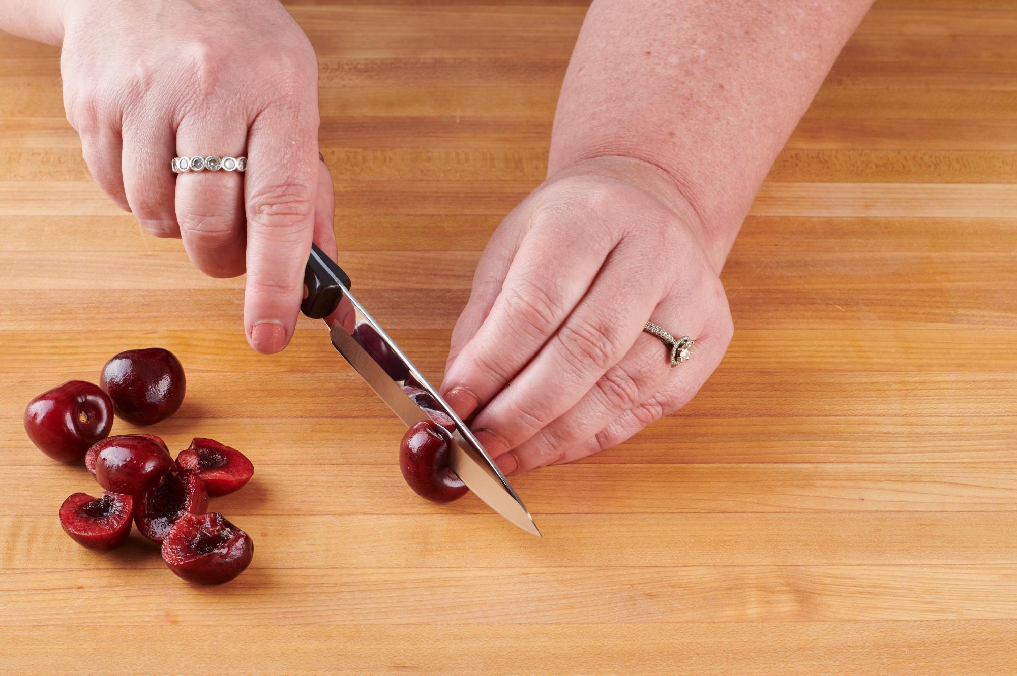 Halving the cherries with a 4 Inch Paring Knife.