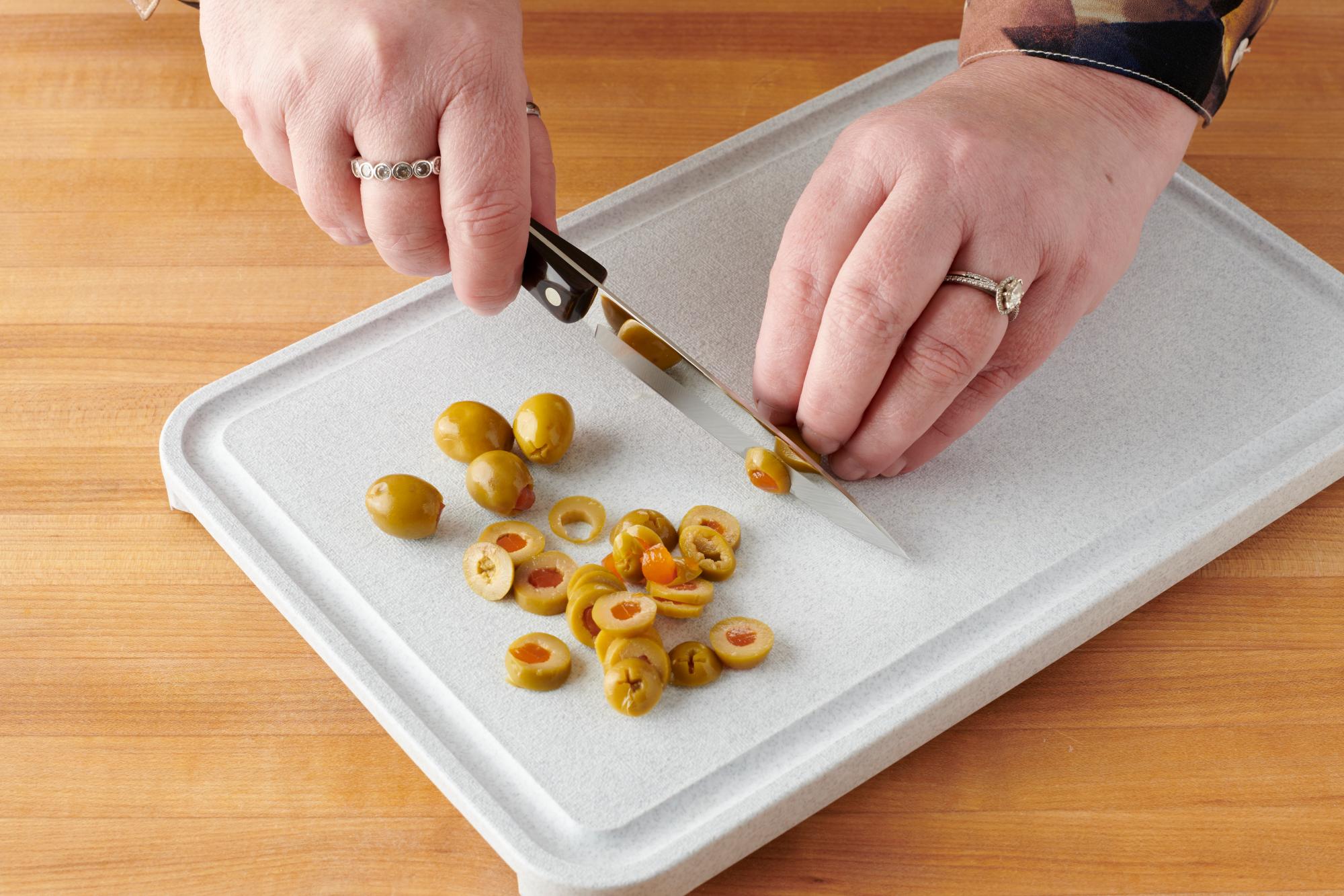Slicing green olives with a 4 Inch Paring Knife.