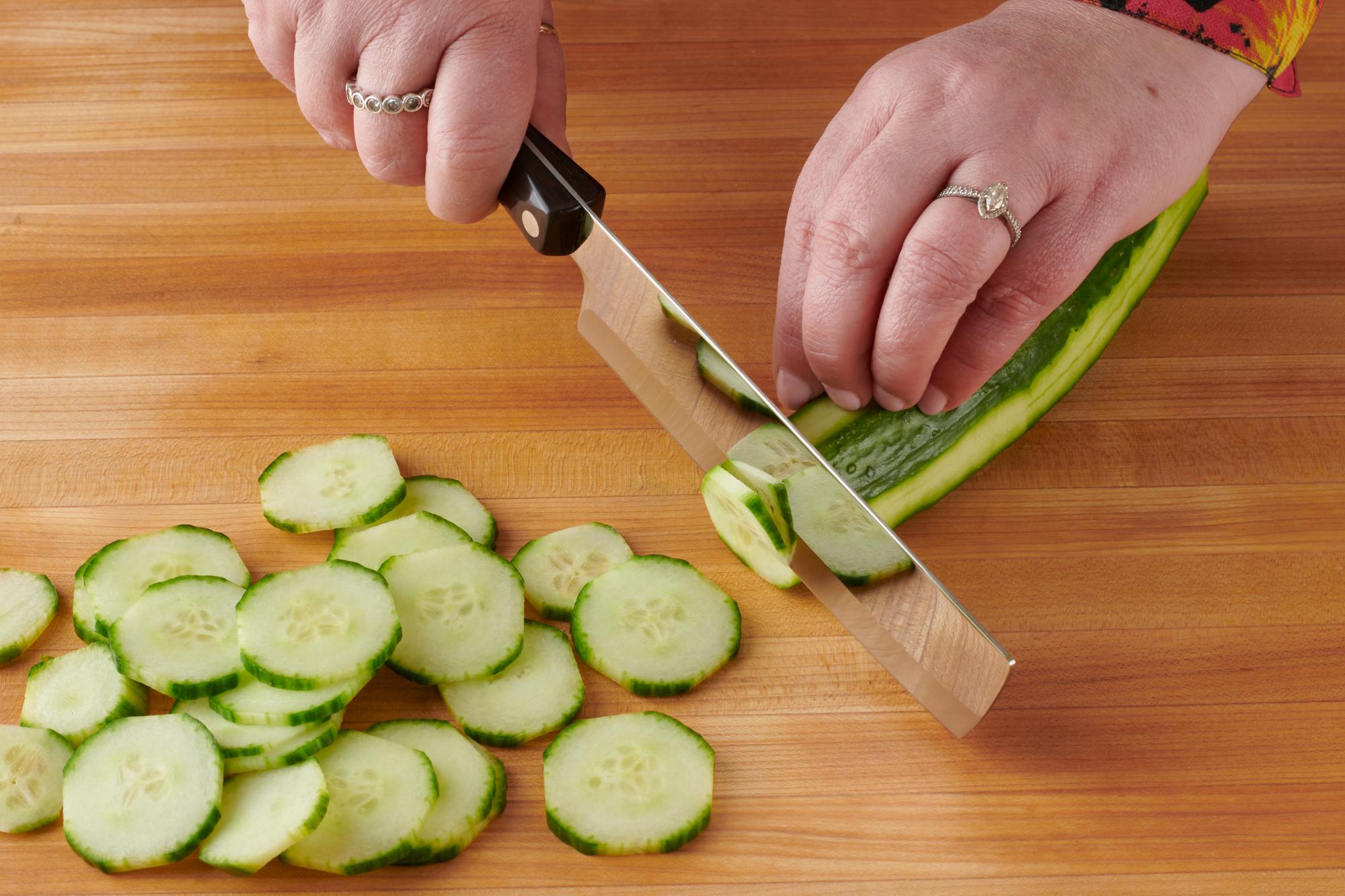 Cutting cucumber with a 6 Inch Vegetable Knife.