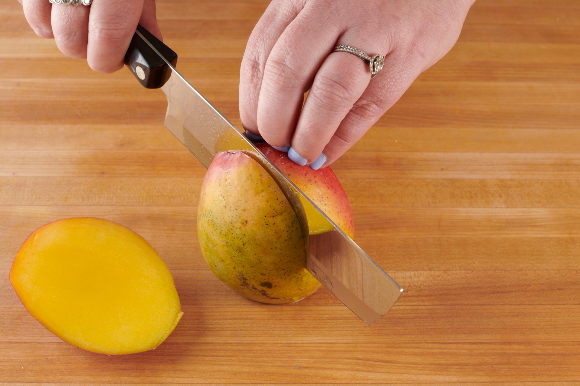 Cutting mango with a 6 Inch Vegetable Knife.