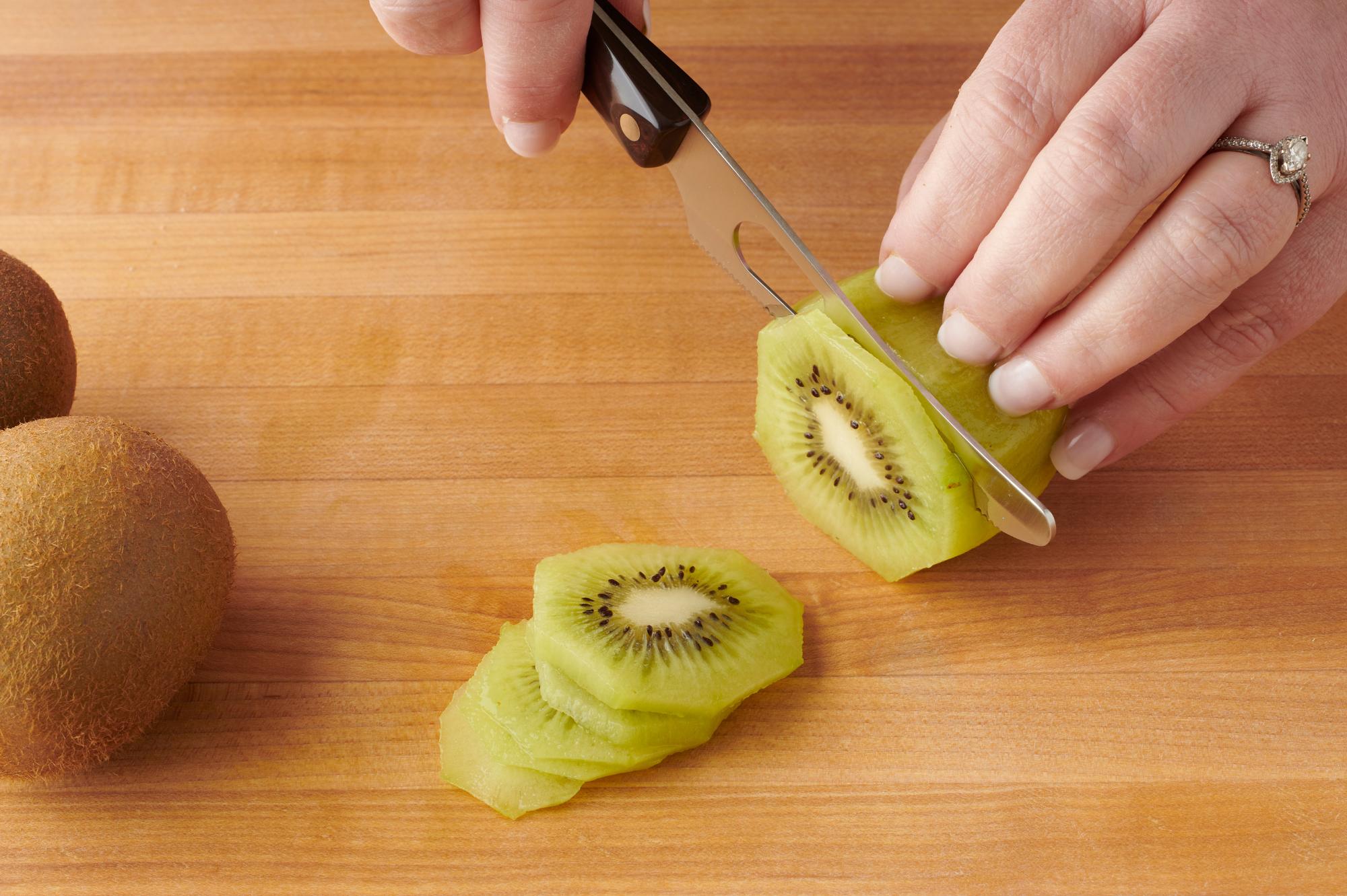Cut kiwi with a Mini Cheese Knife.