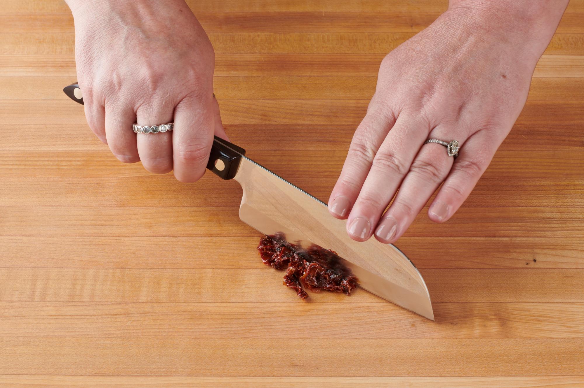 Chopping the sundried tomatoes with a Petite Santoku.