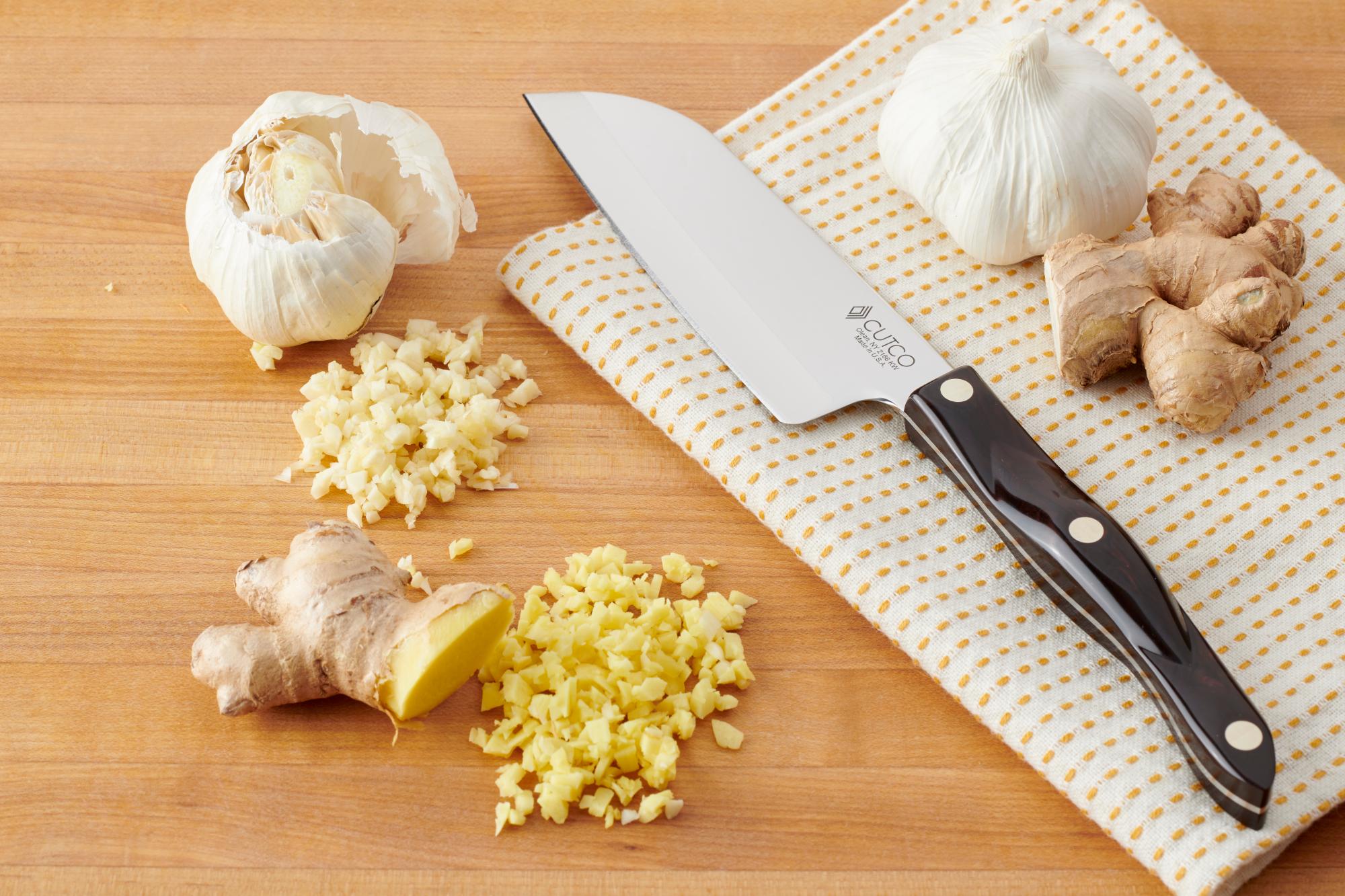 Using a 5 Inch Petite Santoku to mince garlic and ginger.