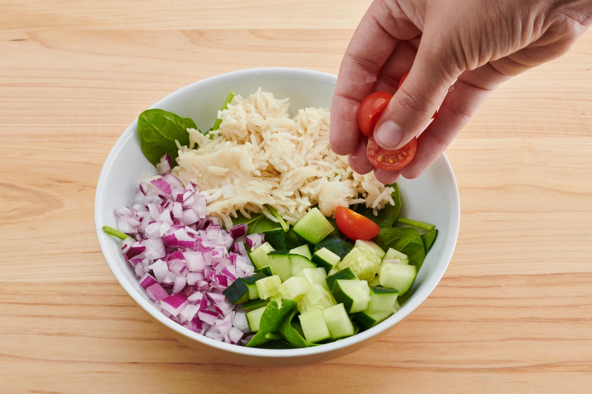 Placing the tomatoes on the bowl.