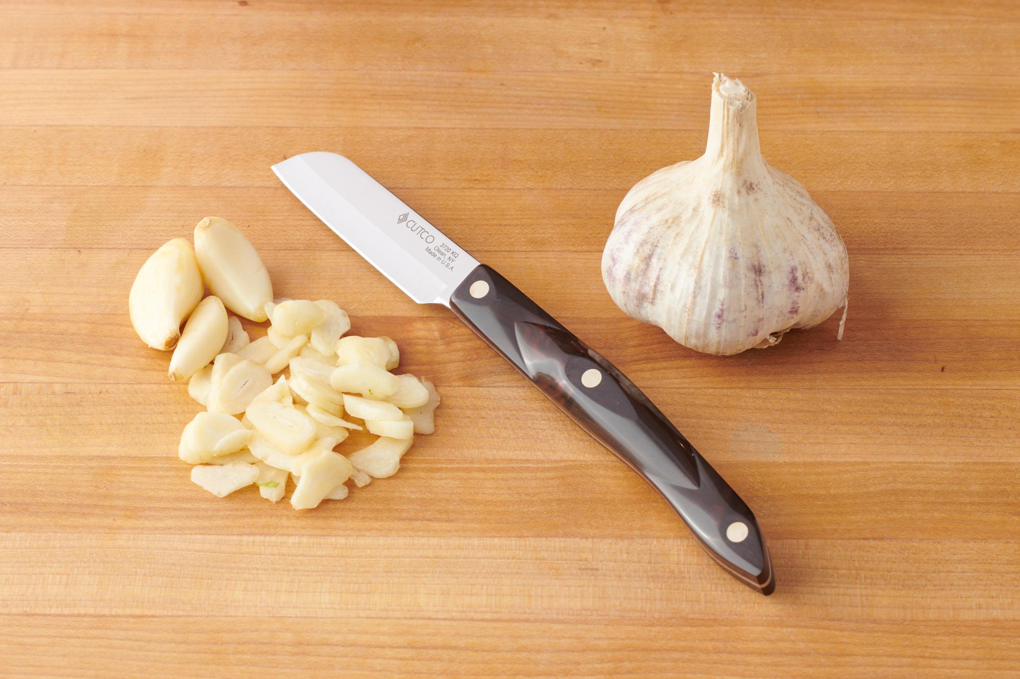 Slice the garlic with a Santoku.