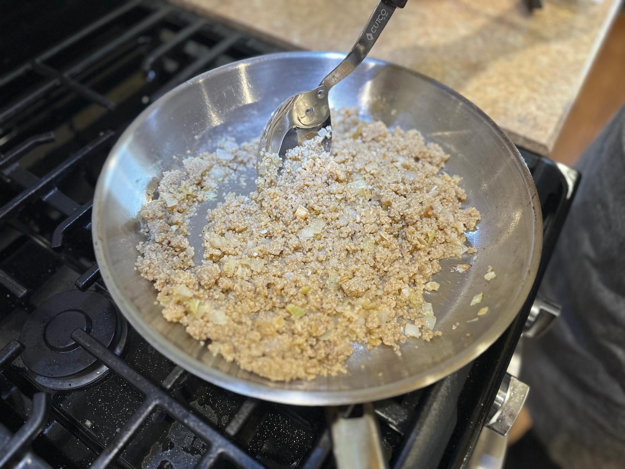  Toasting the quinoa in the pan.